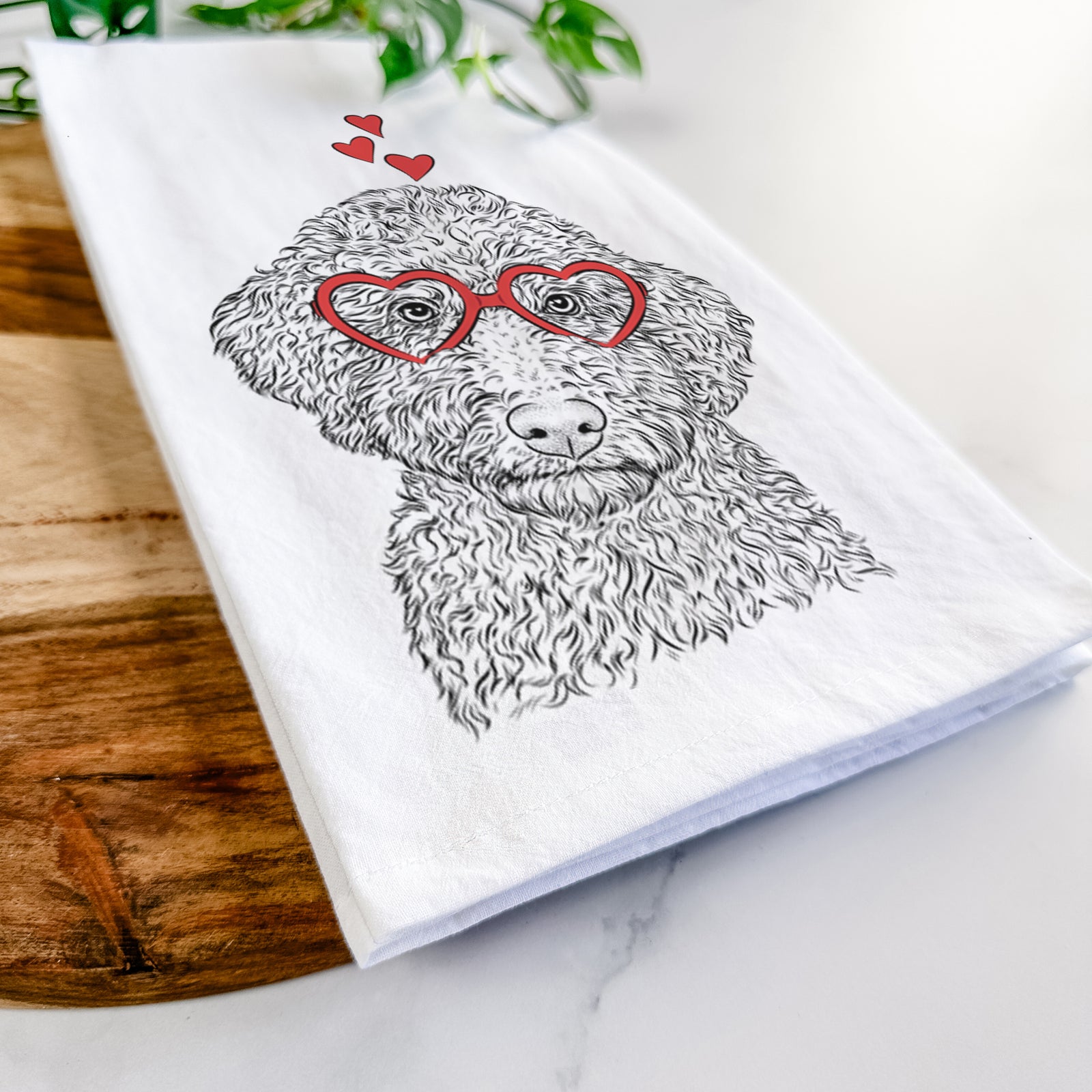 Hand-drawn sketch of Ross the Lagotto Romagnolo wearing heart-shaped glasses on a tea towel