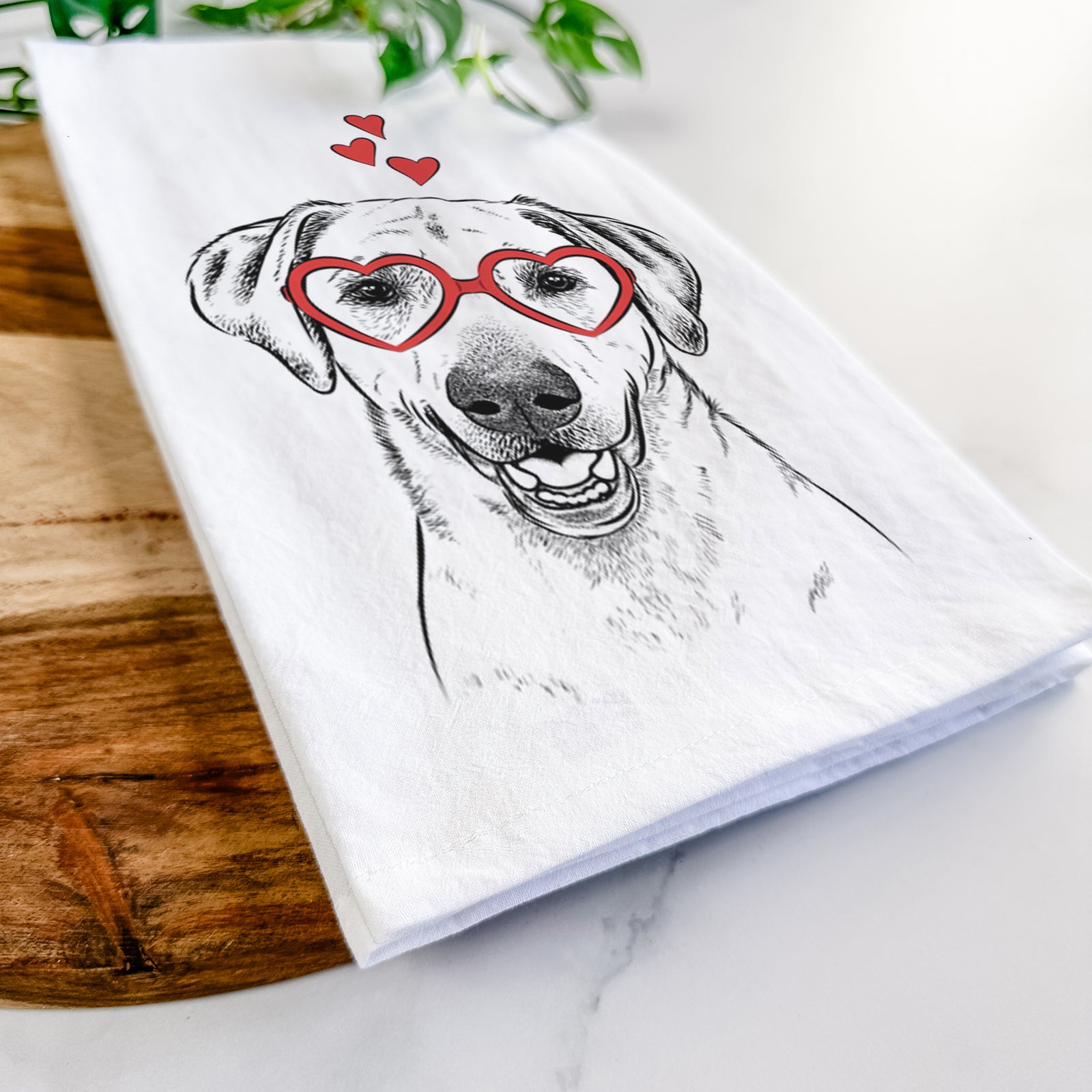 Hand-drawn sketch of Rusty the Labrador Retriever wearing heart-shaped glasses on a tea towel