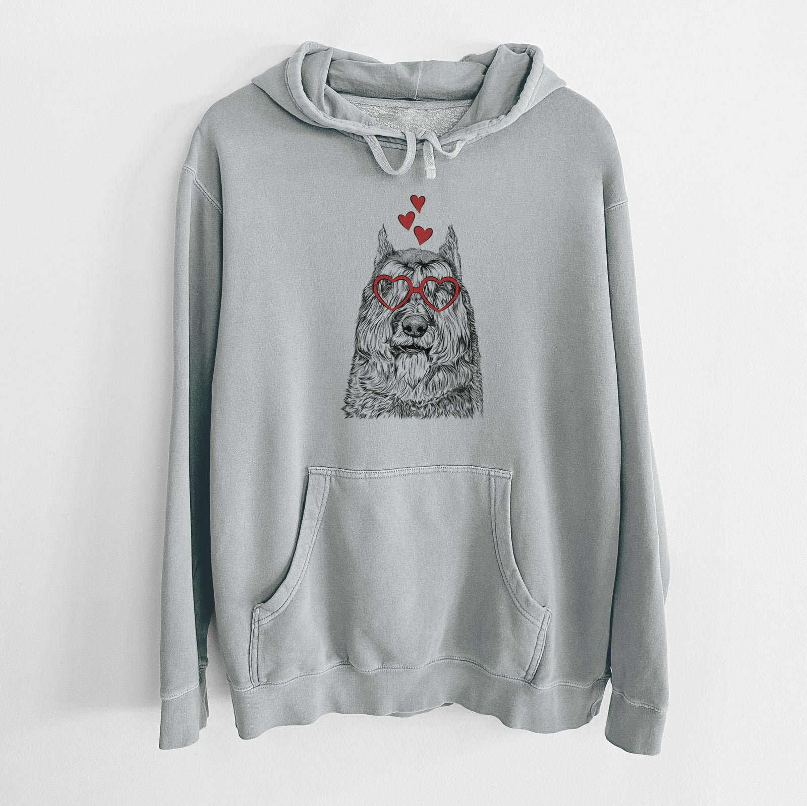 Hand-drawn sketch of Sabre the Bouvier Des Flandres wearing heart-shaped glasses on a Sage Unisex pigment dyed hoodie
