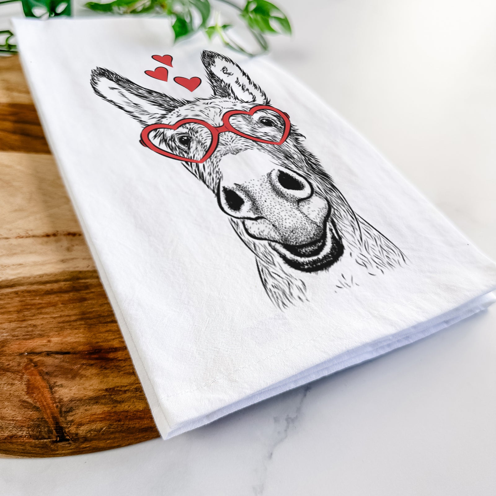 Hand-drawn sketch of Samule the Donkey wearing heart-shaped glasses on a tea towel