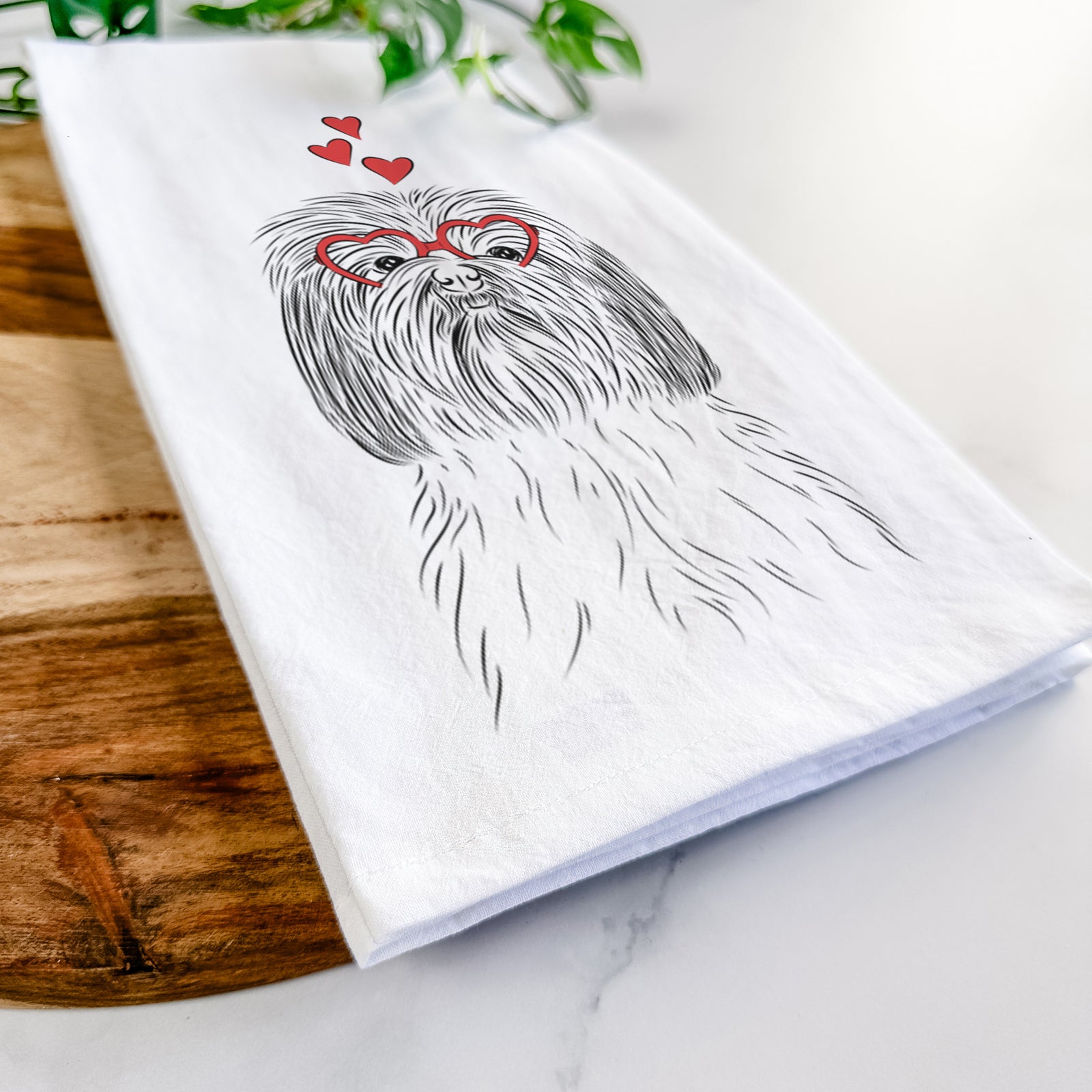 Hand-drawn sketch of Scully the Shih Tzu wearing heart-shaped glasses on a tea towel