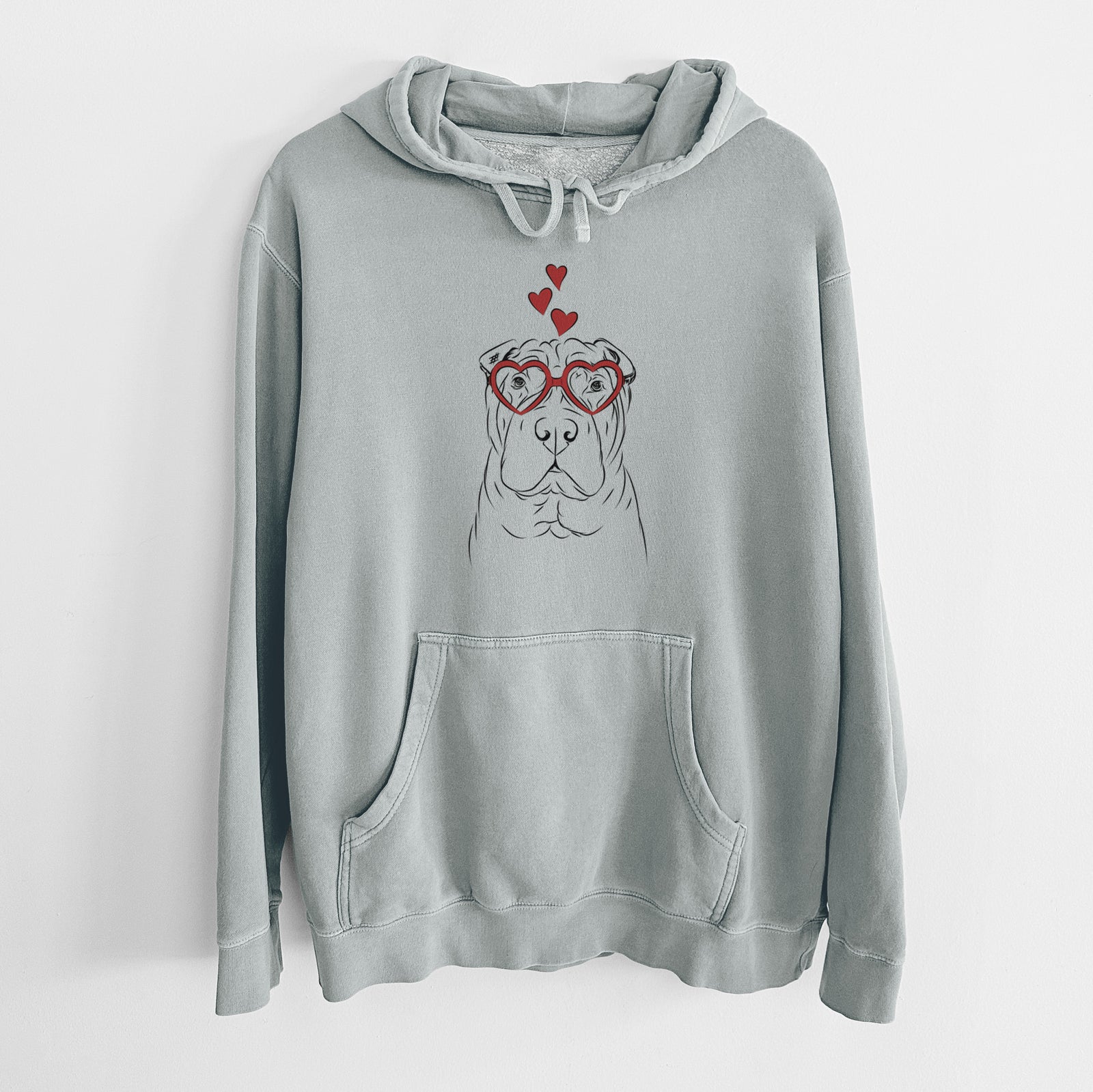 Hand-drawn sketch of Sharpy the Shar Pei wearing heart-shaped glasses on a Sage Unisex pigment dyed hoodie