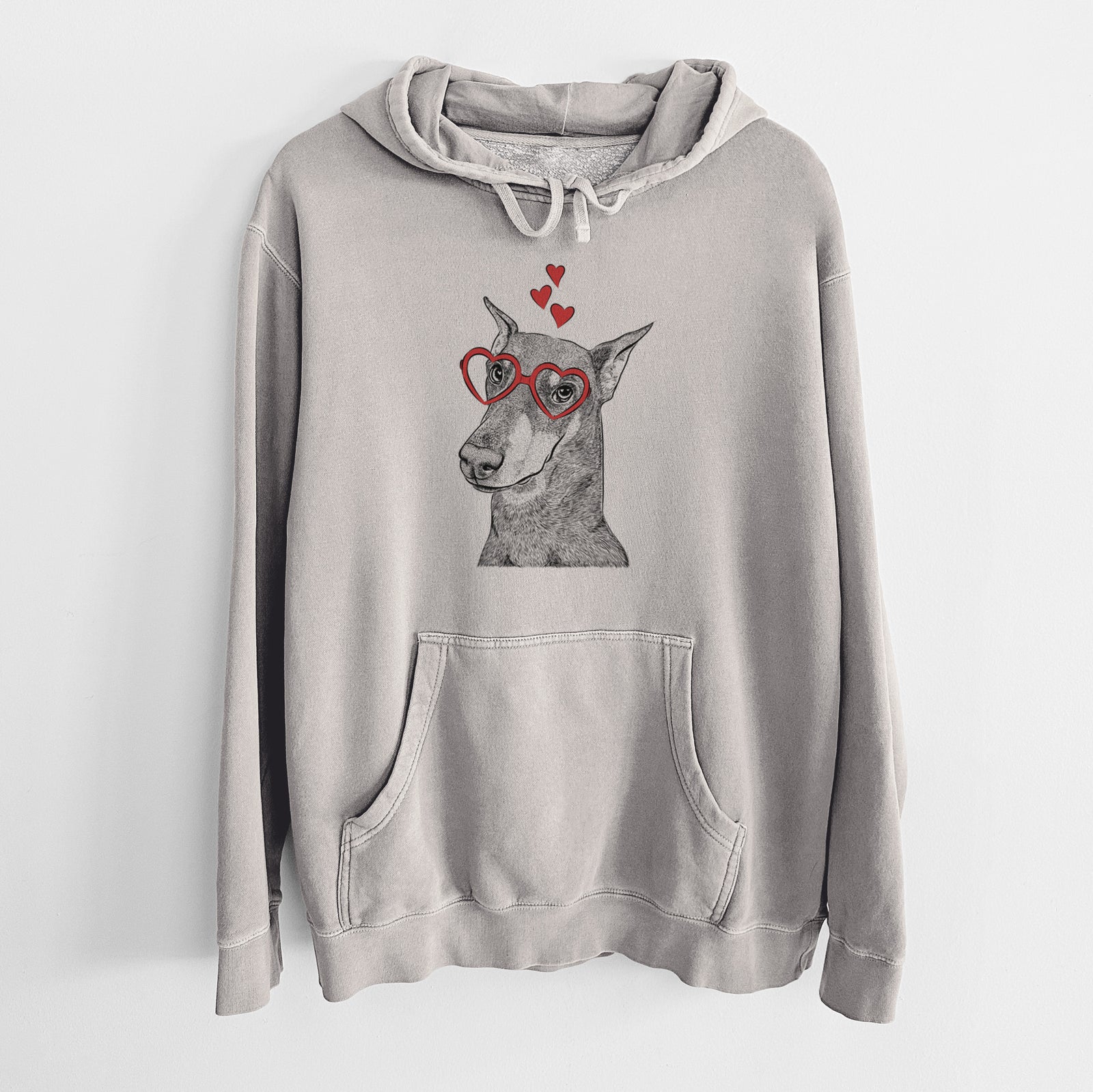 Hand-drawn sketch of Shelby the Doberman Pinscher wearing heart-shaped glasses on a Cement Unisex pigment dyed hoodie