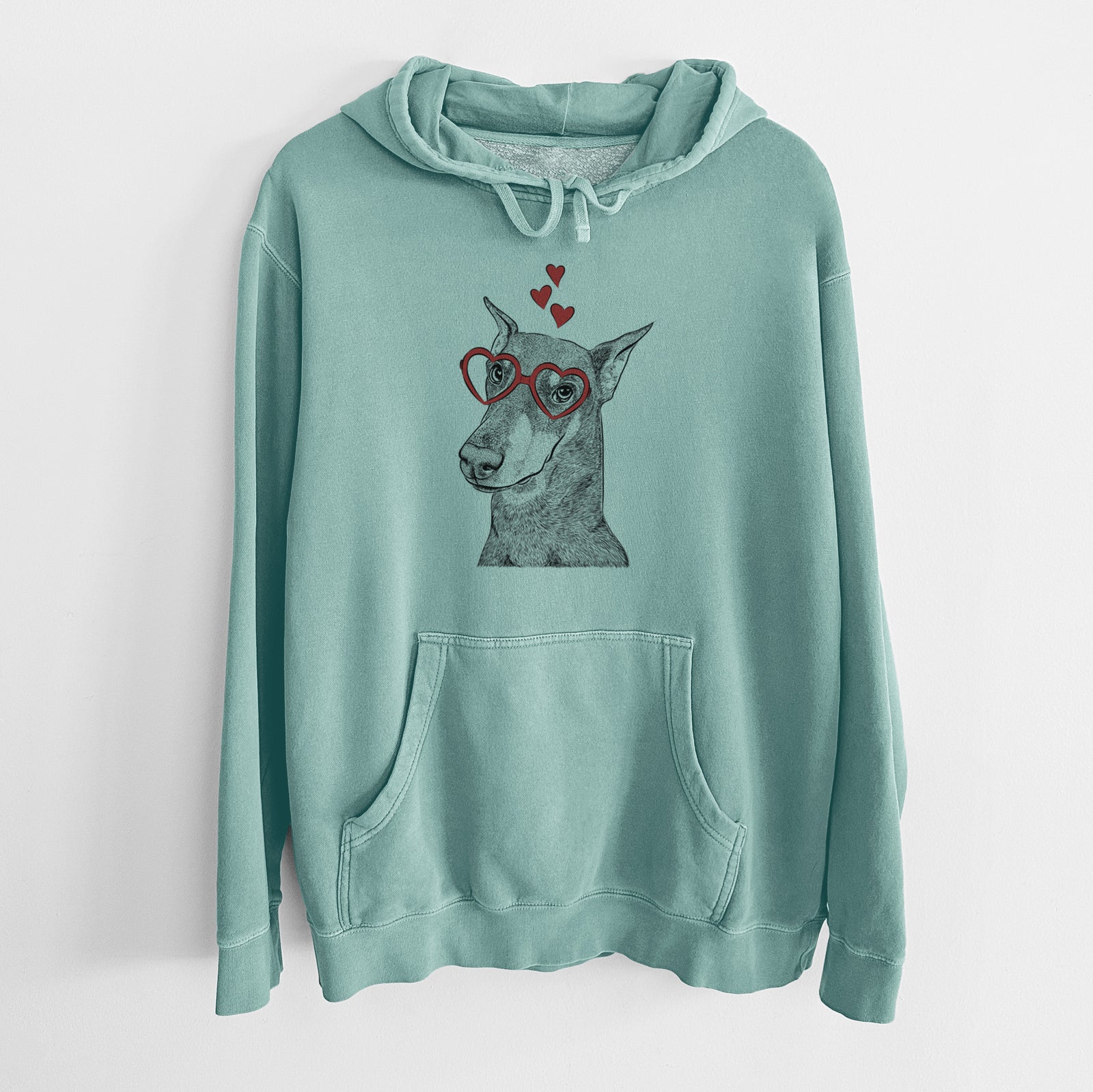 Hand-drawn sketch of Shelby the Doberman Pinscher wearing heart-shaped glasses on a Mint Unisex pigment dyed hoodie