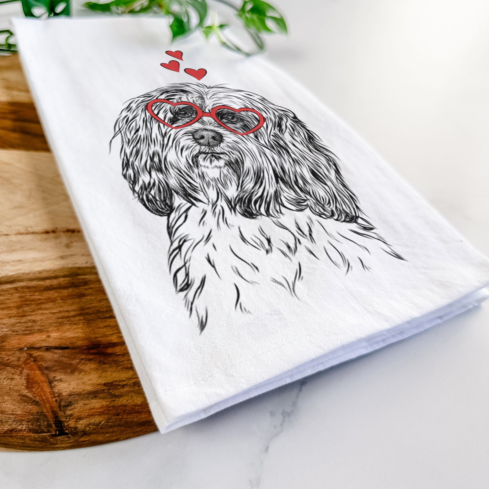 Hand-drawn sketch of Shenpa the Tibetan Terrier wearing heart-shaped glasses on a tea towel