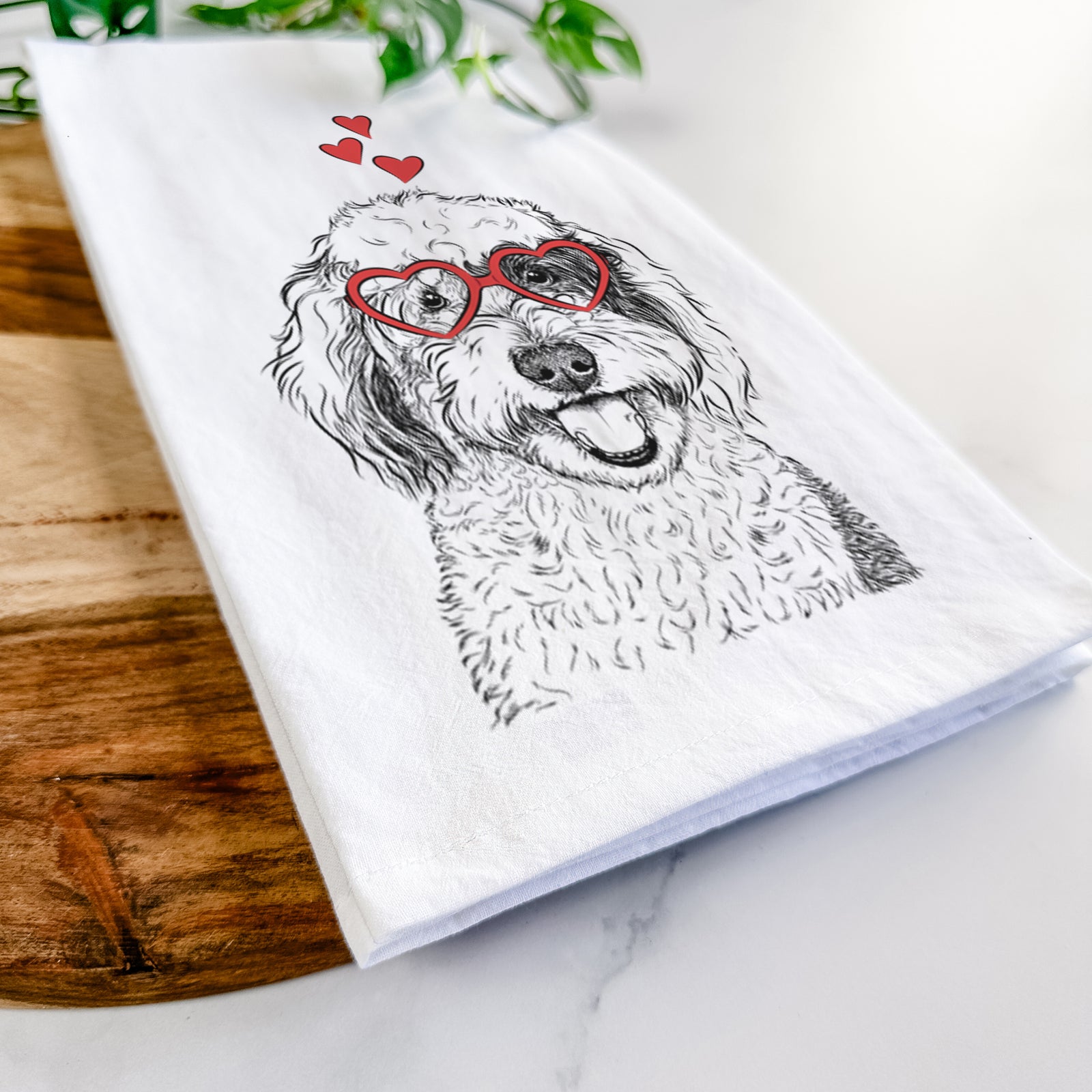 Hand-drawn sketch of Sherlock the Sheepadoodle wearing heart-shaped glasses on a tea towel