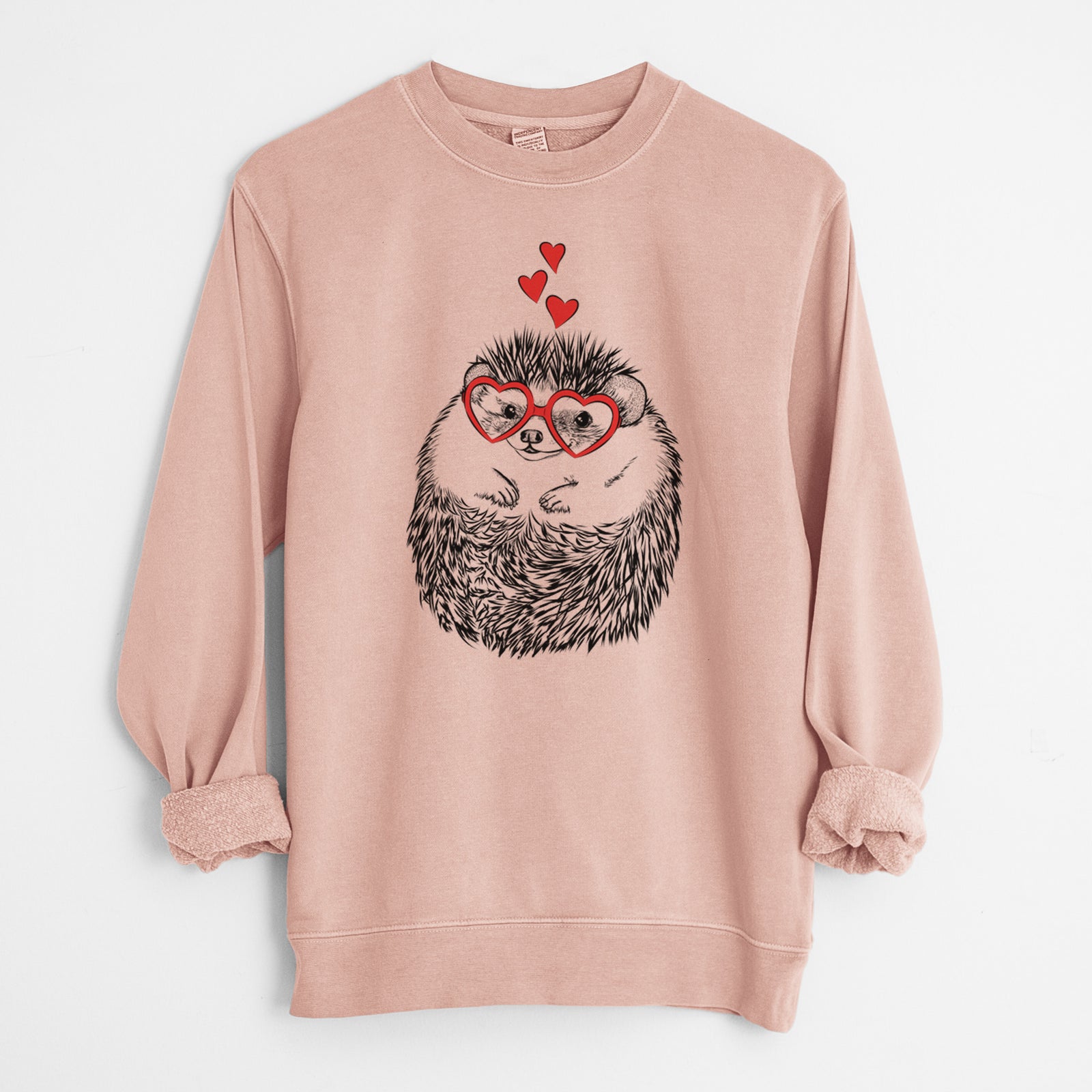Hand-drawn sketch of Sid the Hedgehog wearing heart-shaped glasses on a Dusty Pink Unisex pigment dyed crew sweatshirt