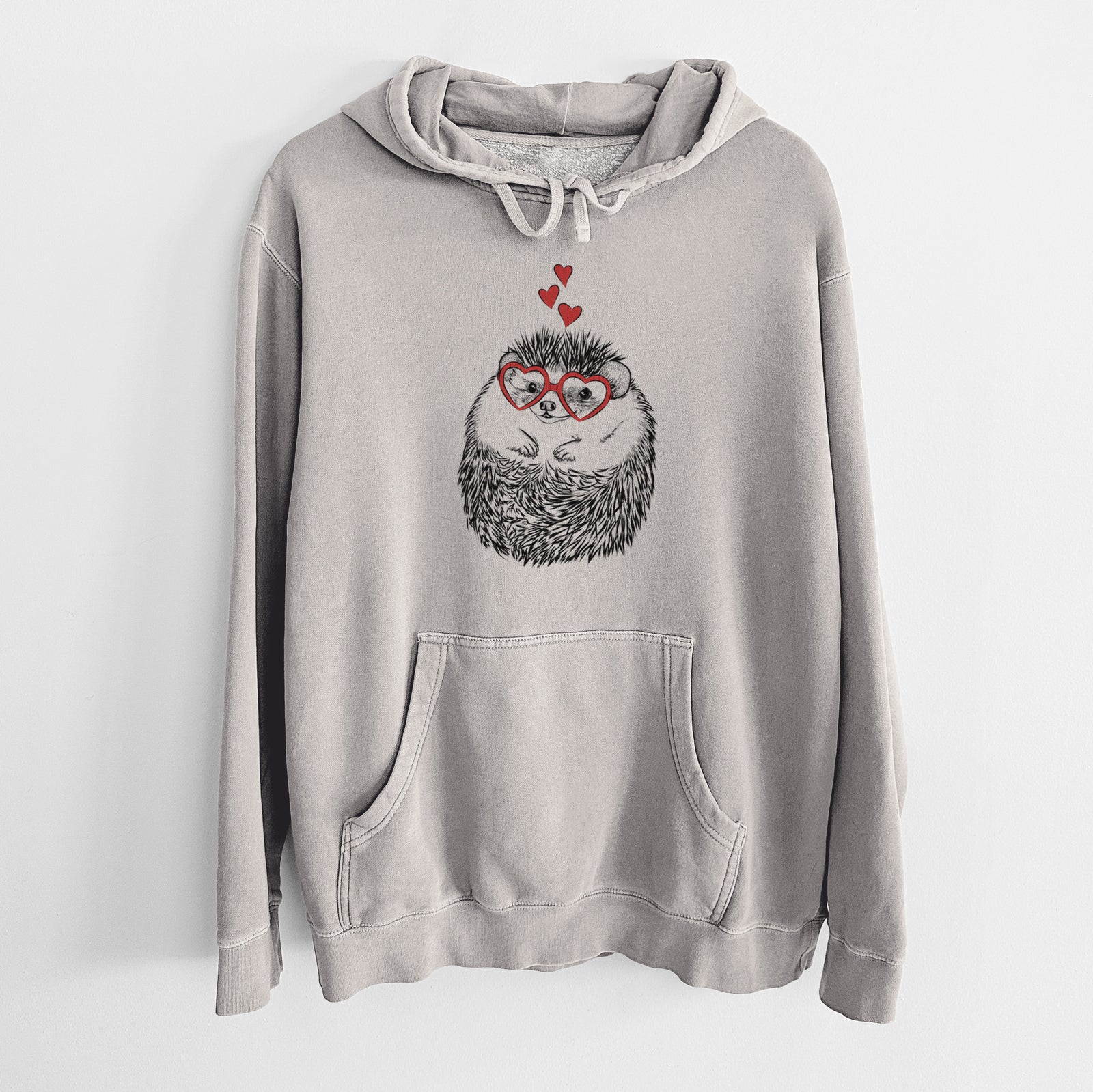 Hand-drawn sketch of Sid the Hedgehog wearing heart-shaped glasses on a Cement Unisex pigment dyed hoodie