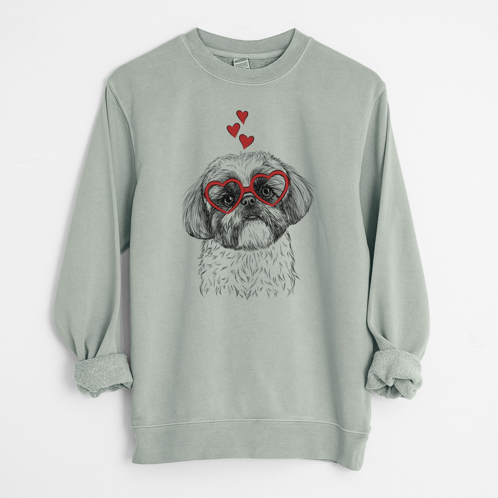 Hand-drawn sketch of Simon the Shih Tzu wearing heart-shaped glasses on a Sage Unisex pigment dyed crew sweatshirt