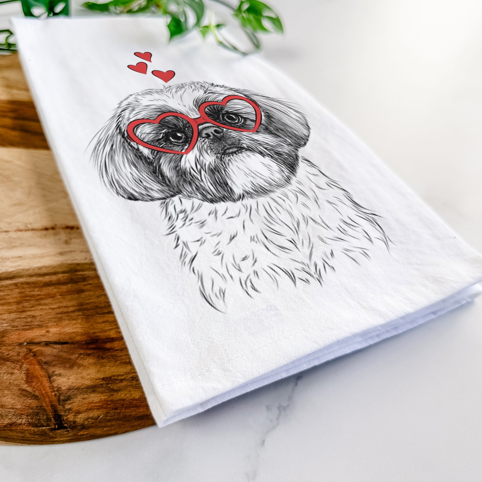 Hand-drawn sketch of Simon the Shih Tzu wearing heart-shaped glasses on a tea towel