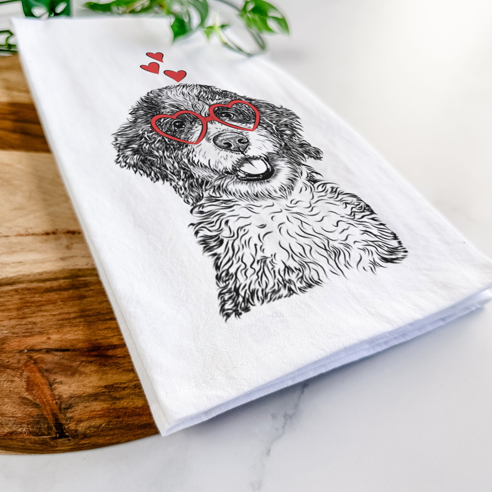 Hand-drawn sketch of Smoky the Bernedoodle Puppy wearing heart-shaped glasses on a tea towel
