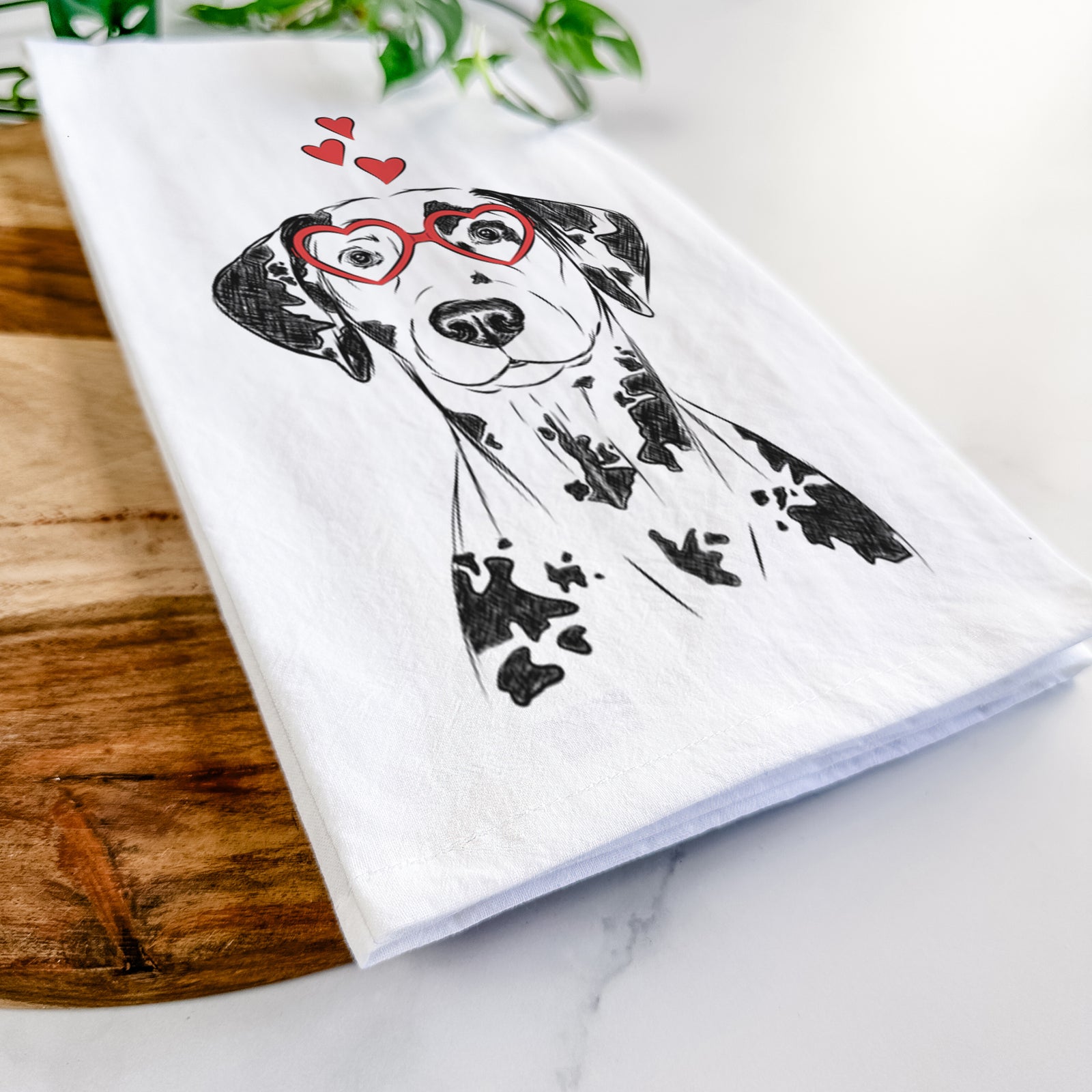 Hand-drawn sketch of Spot the Dalmatian wearing heart-shaped glasses on a tea towel