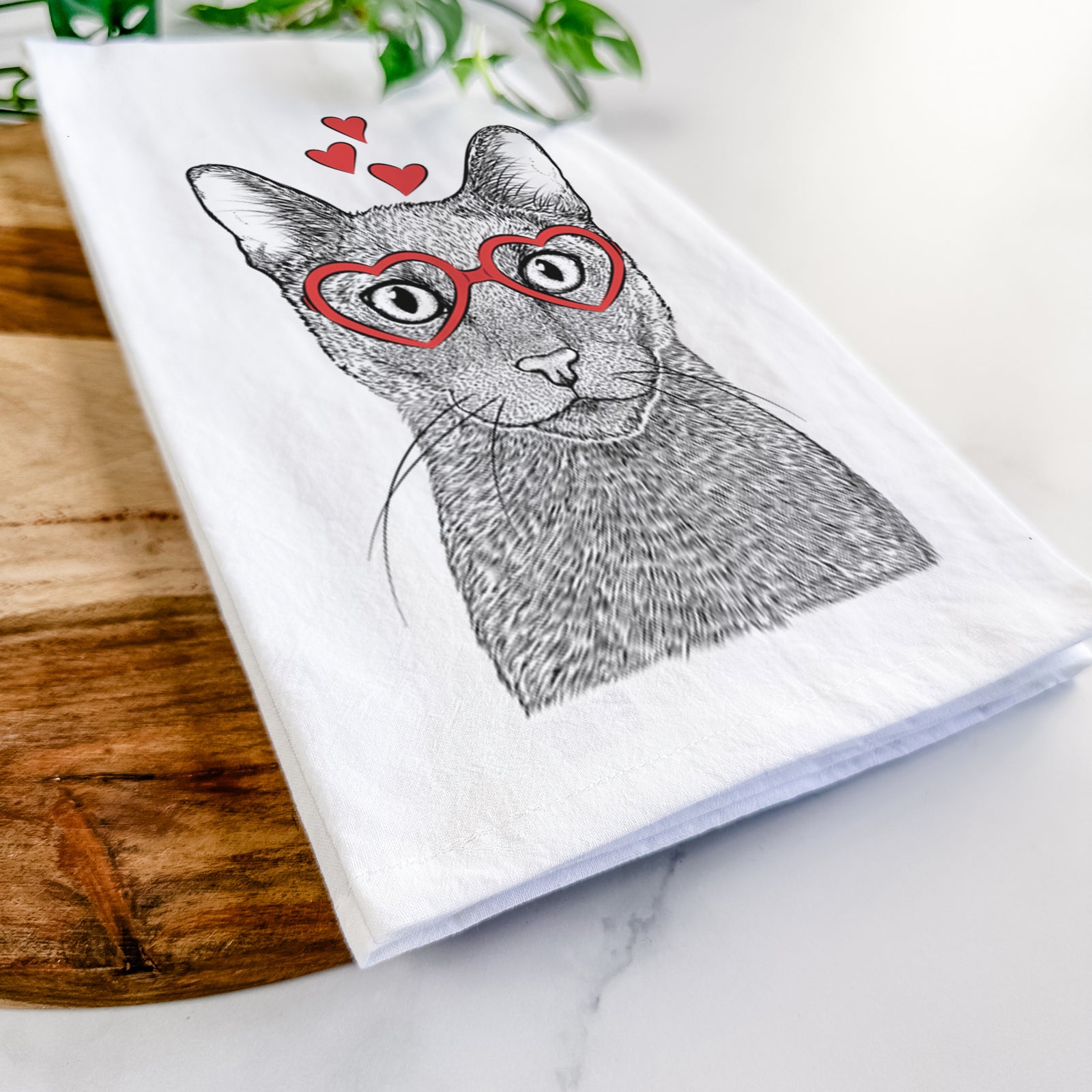 Hand-drawn sketch of Stanley the Russian Blue Cat wearing heart-shaped glasses on a tea towel