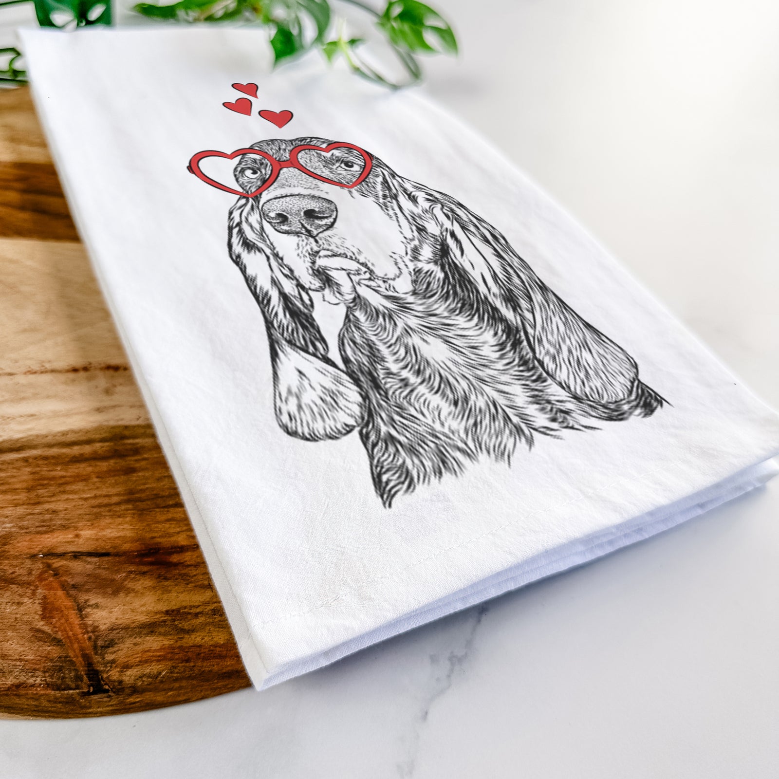 Hand-drawn sketch of Stu the Black and Tan Coonhound wearing heart-shaped glasses on a tea towel