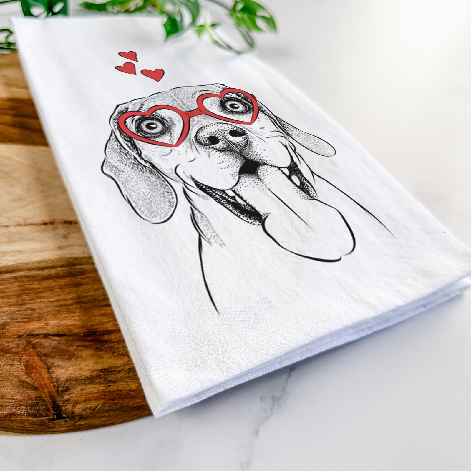 Hand-drawn sketch of Sunny the Beagle wearing heart-shaped glasses on a tea towel