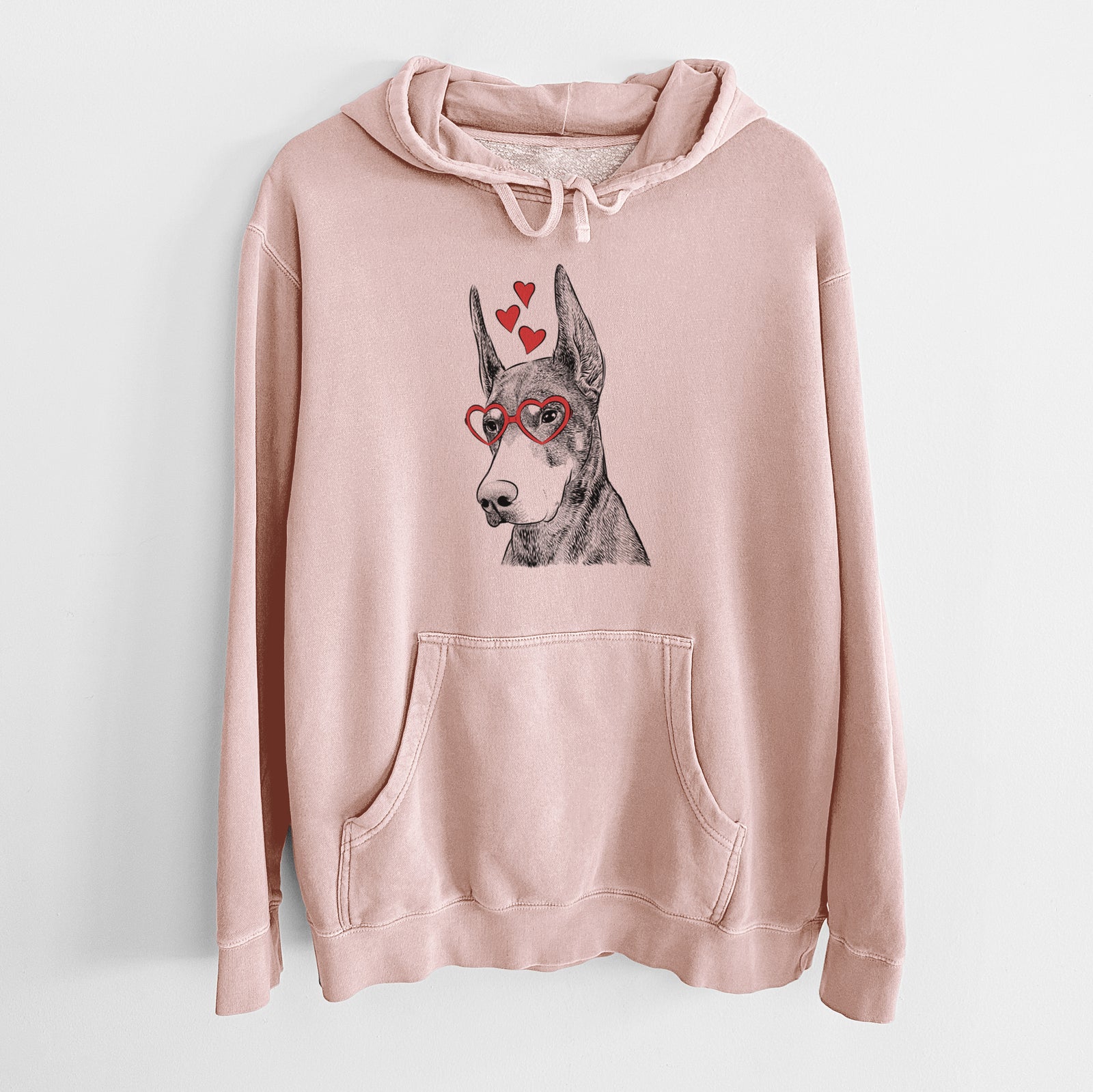 Hand-drawn sketch of Sunny the Doberman Pinscher wearing heart-shaped glasses on a Dusty Pink Unisex pigment dyed hoodie