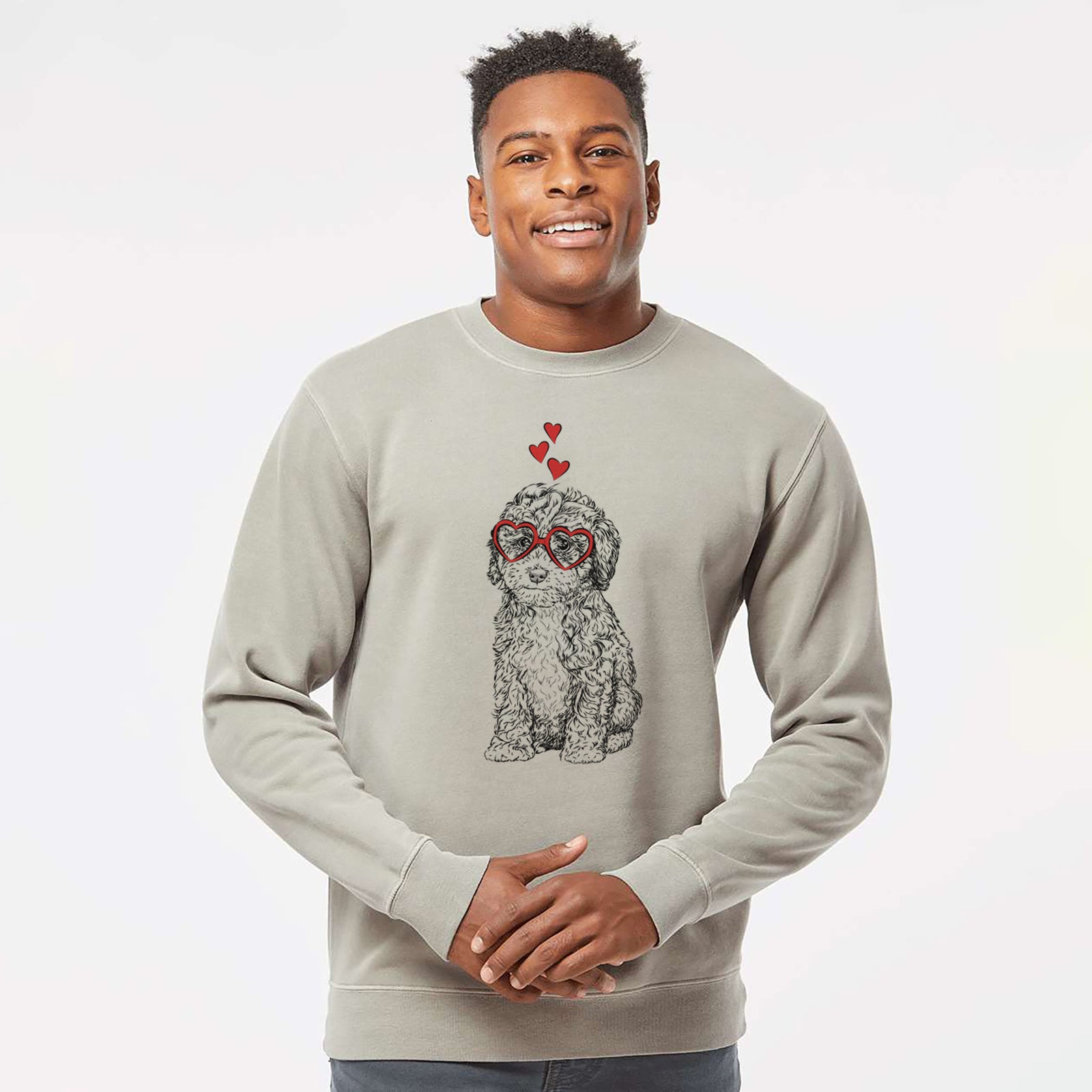 Hand-drawn sketch of Sweet Tea the Mini Doodle wearing heart-shaped glasses on a Cement Unisex pigment dyed crew sweatshirt