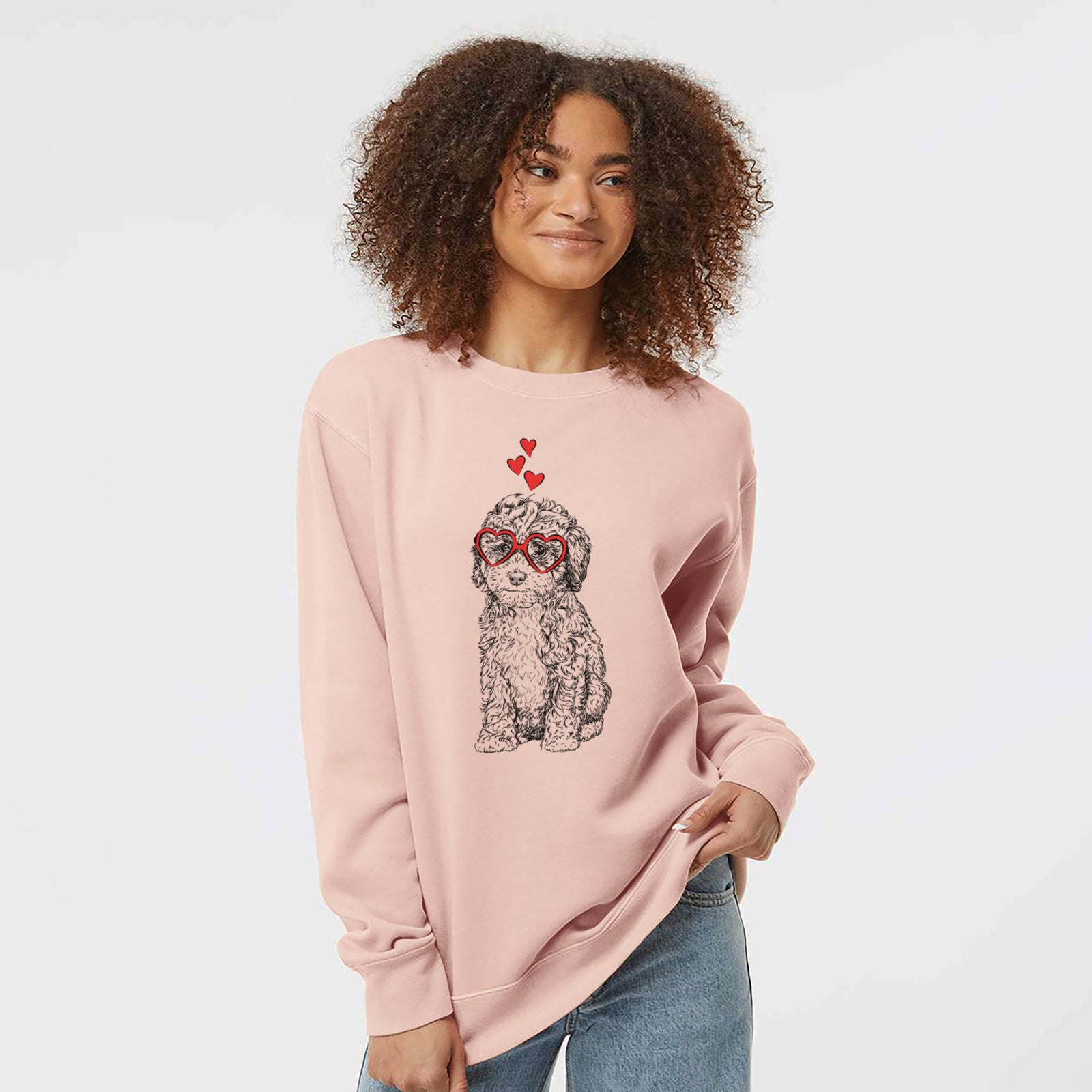 Hand-drawn sketch of Sweet Tea the Mini Doodle wearing heart-shaped glasses on a Dusty Pink Unisex pigment dyed crew sweatshirt