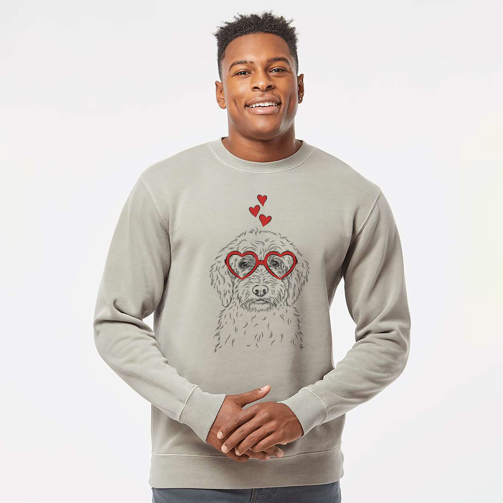 Hand-drawn sketch of Teddy the Labradoodle wearing heart-shaped glasses on a Cement Unisex pigment dyed crew sweatshirt