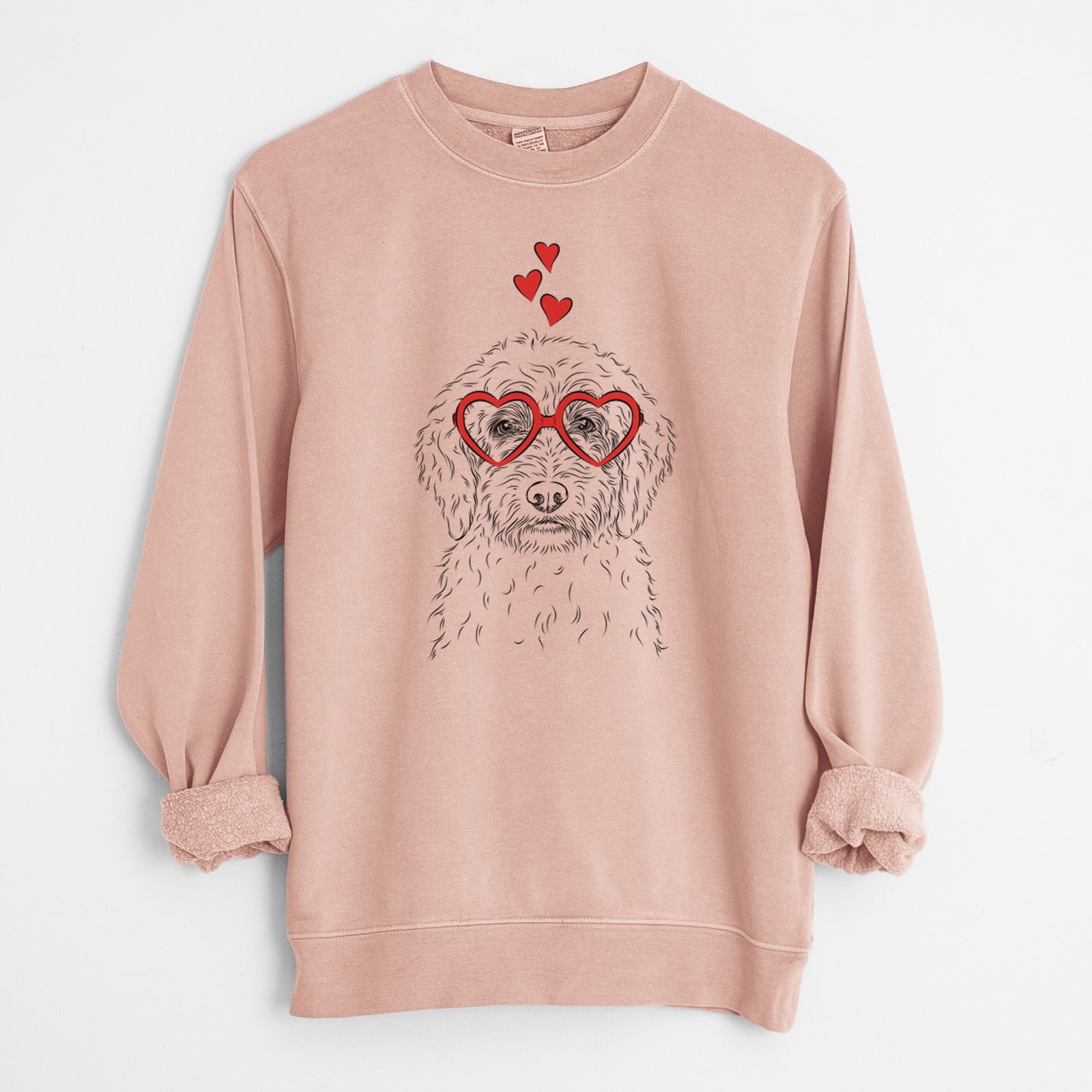 Hand-drawn sketch of Teddy the Labradoodle wearing heart-shaped glasses on a Dusty Pink Unisex pigment dyed crew sweatshirt