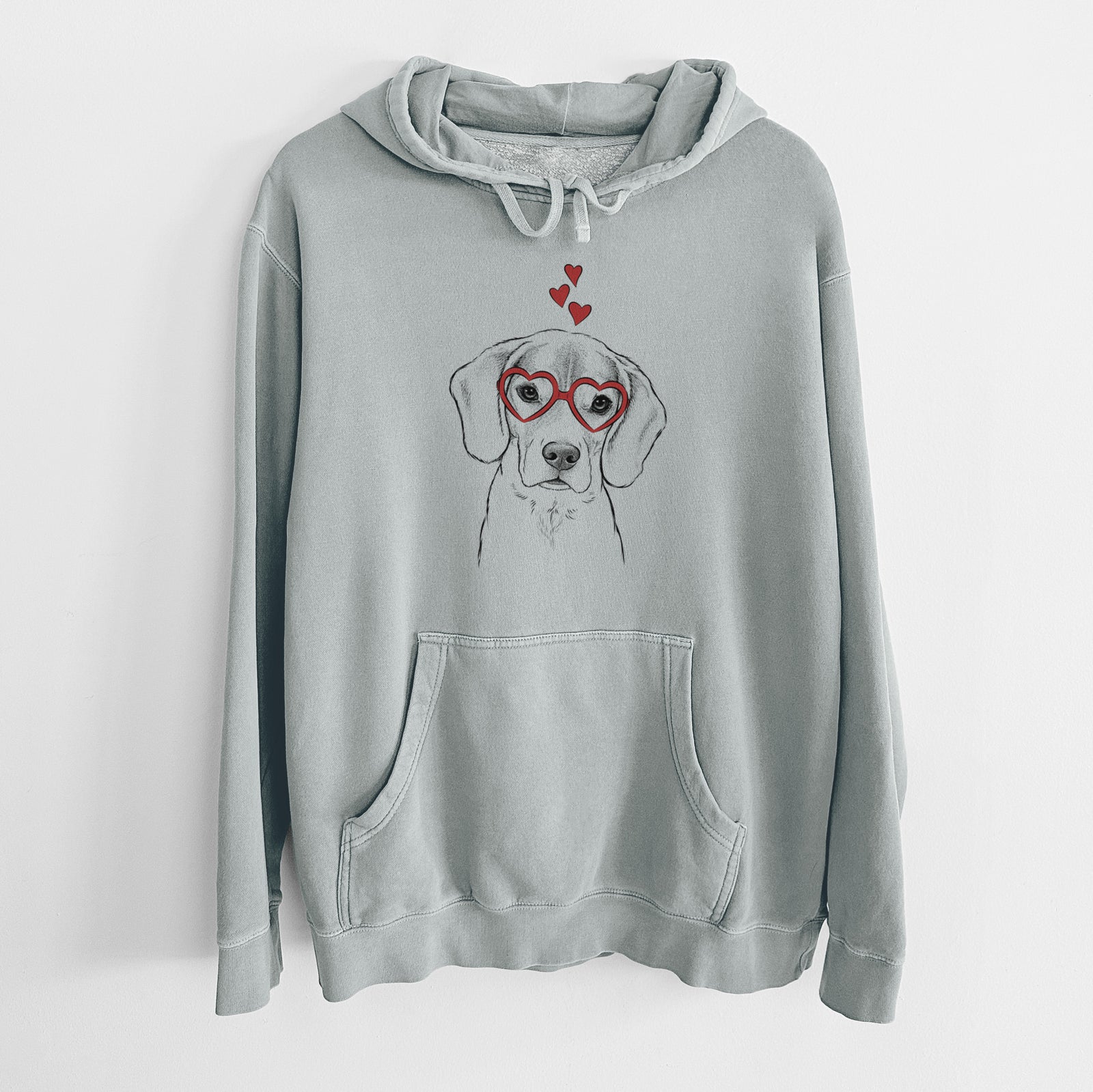 Hand-drawn sketch of Thea the Beagle wearing heart-shaped glasses on a Sage Unisex pigment dyed hoodie