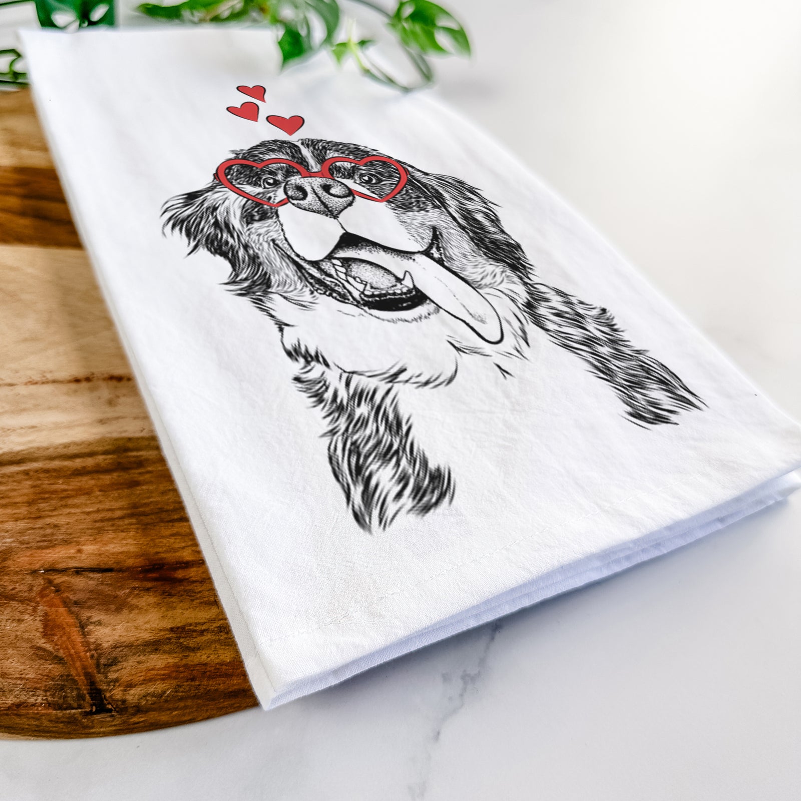 Hand-drawn sketch of Theo the Bernese Mountain Dog wearing heart-shaped glasses on a tea towel