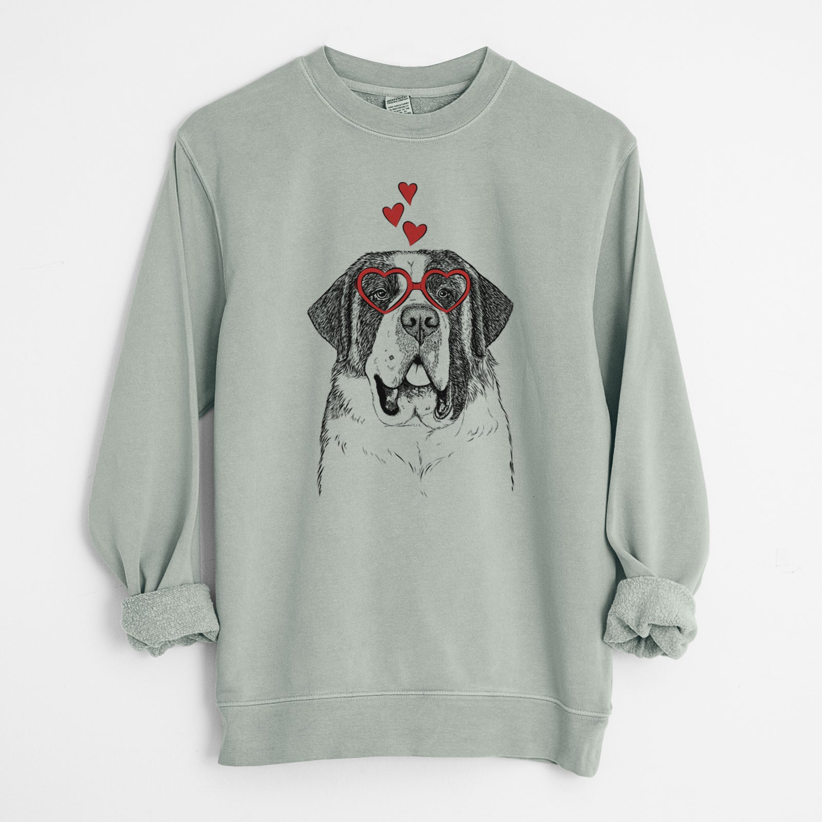 Hand-drawn sketch of Thor the Saint Bernard wearing heart-shaped glasses on a Sage Unisex pigment dyed crew sweatshirt