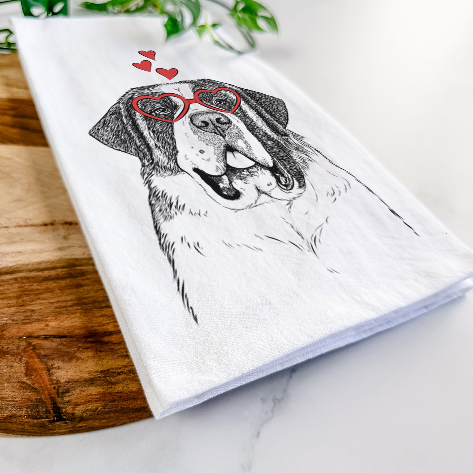 Hand-drawn sketch of Thor the Saint Bernard wearing heart-shaped glasses on a tea towel