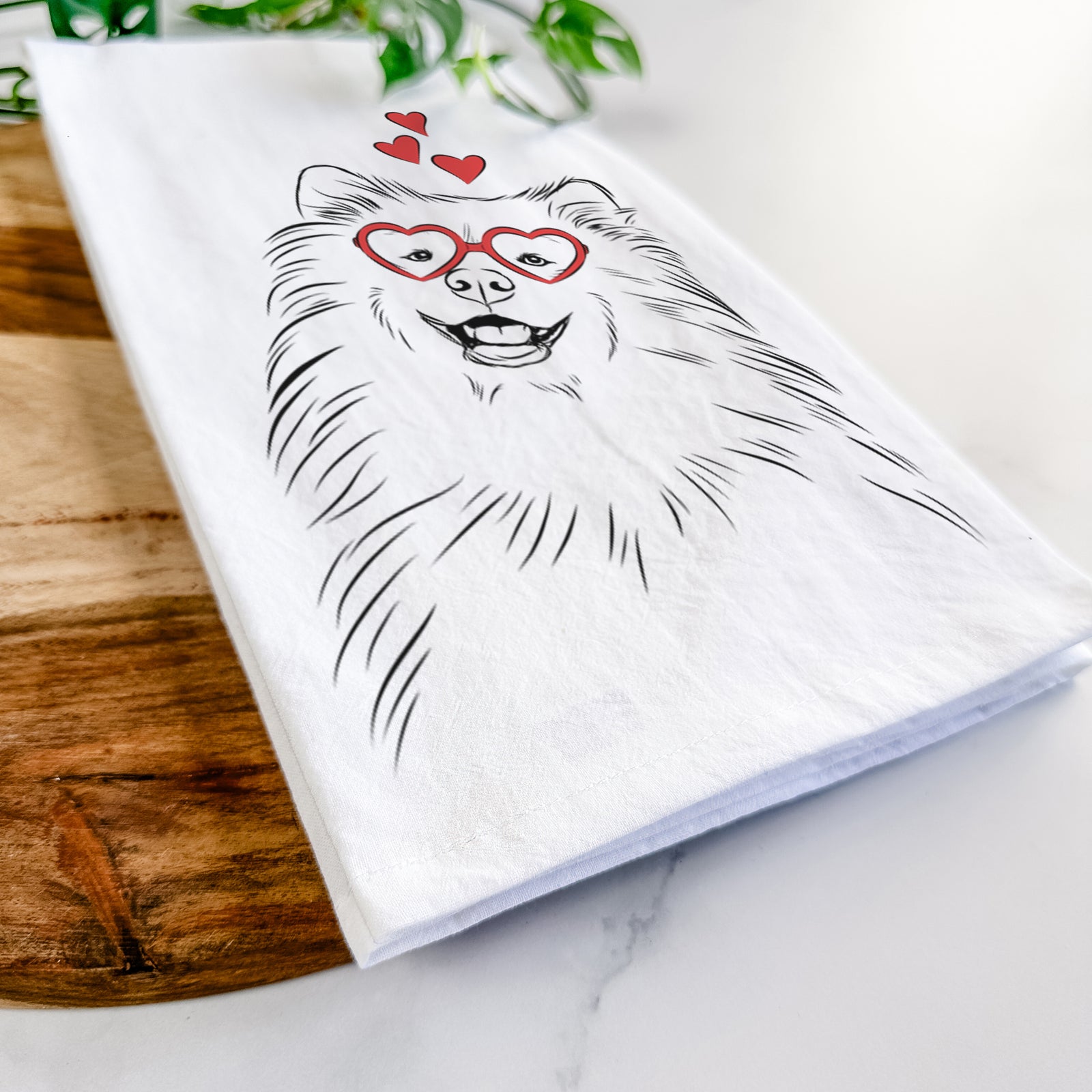 Hand-drawn sketch of Tillie the Samoyed wearing heart-shaped glasses on a tea towel