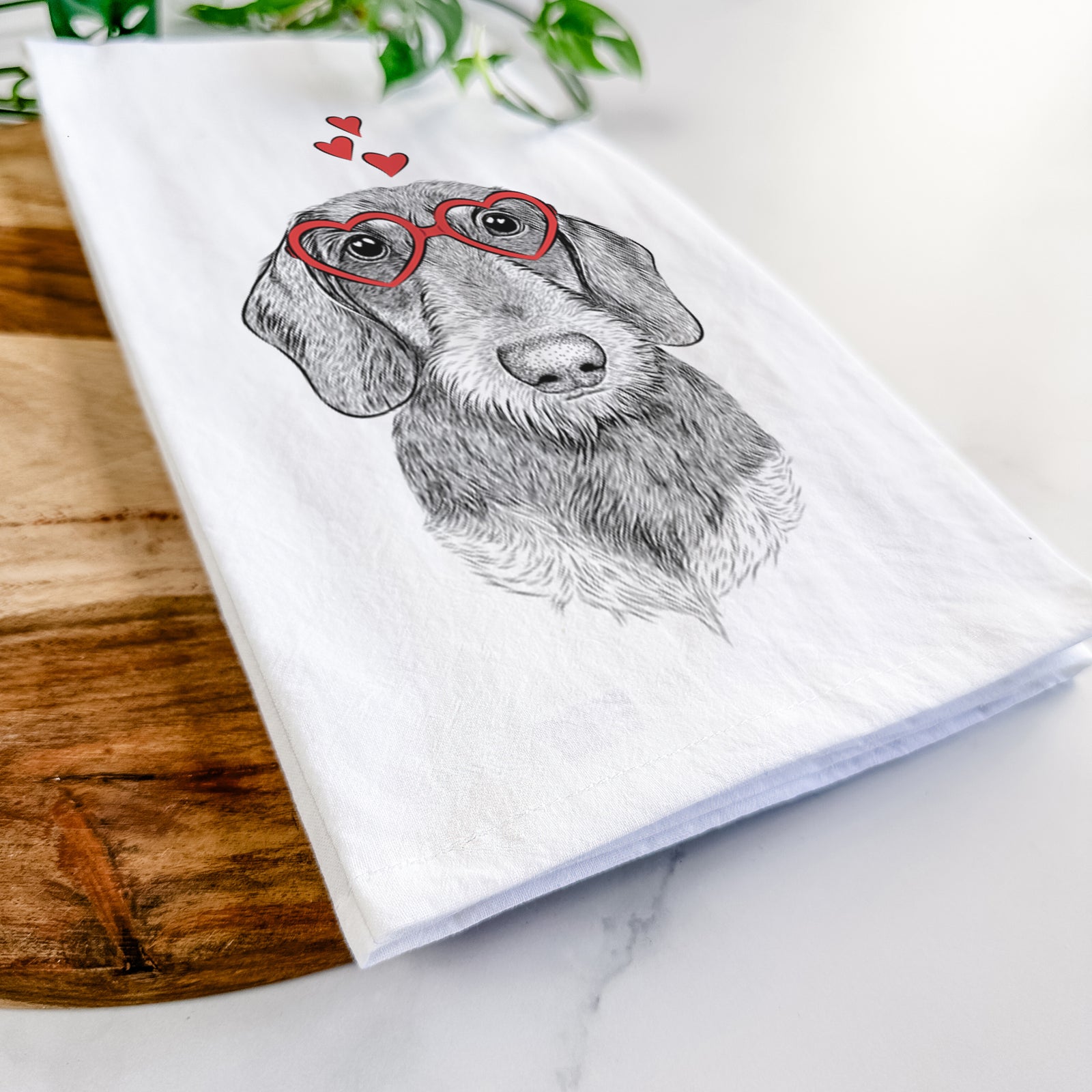 Hand-drawn sketch of Truman the Wirehaired Dachshund wearing heart-shaped glasses on a tea towel