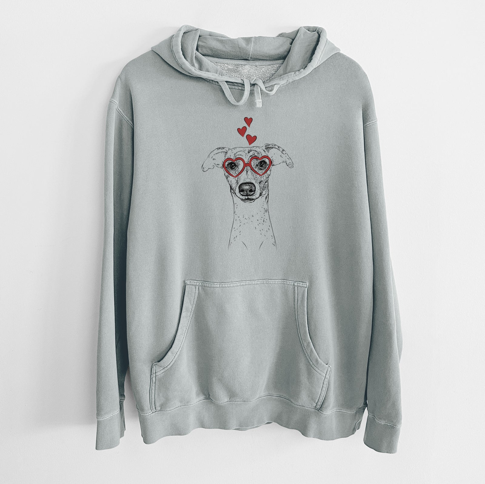 Hand-drawn sketch of Twiggy the Whippet wearing heart-shaped glasses on a Sage Unisex pigment dyed hoodie