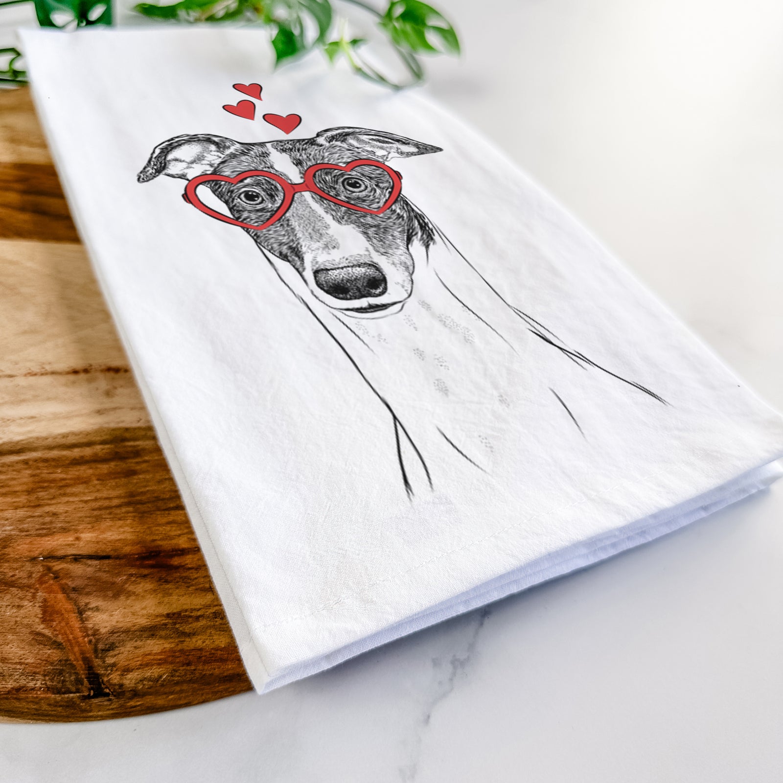 Hand-drawn sketch of Vyncent the Greyhound wearing heart-shaped glasses on a tea towel