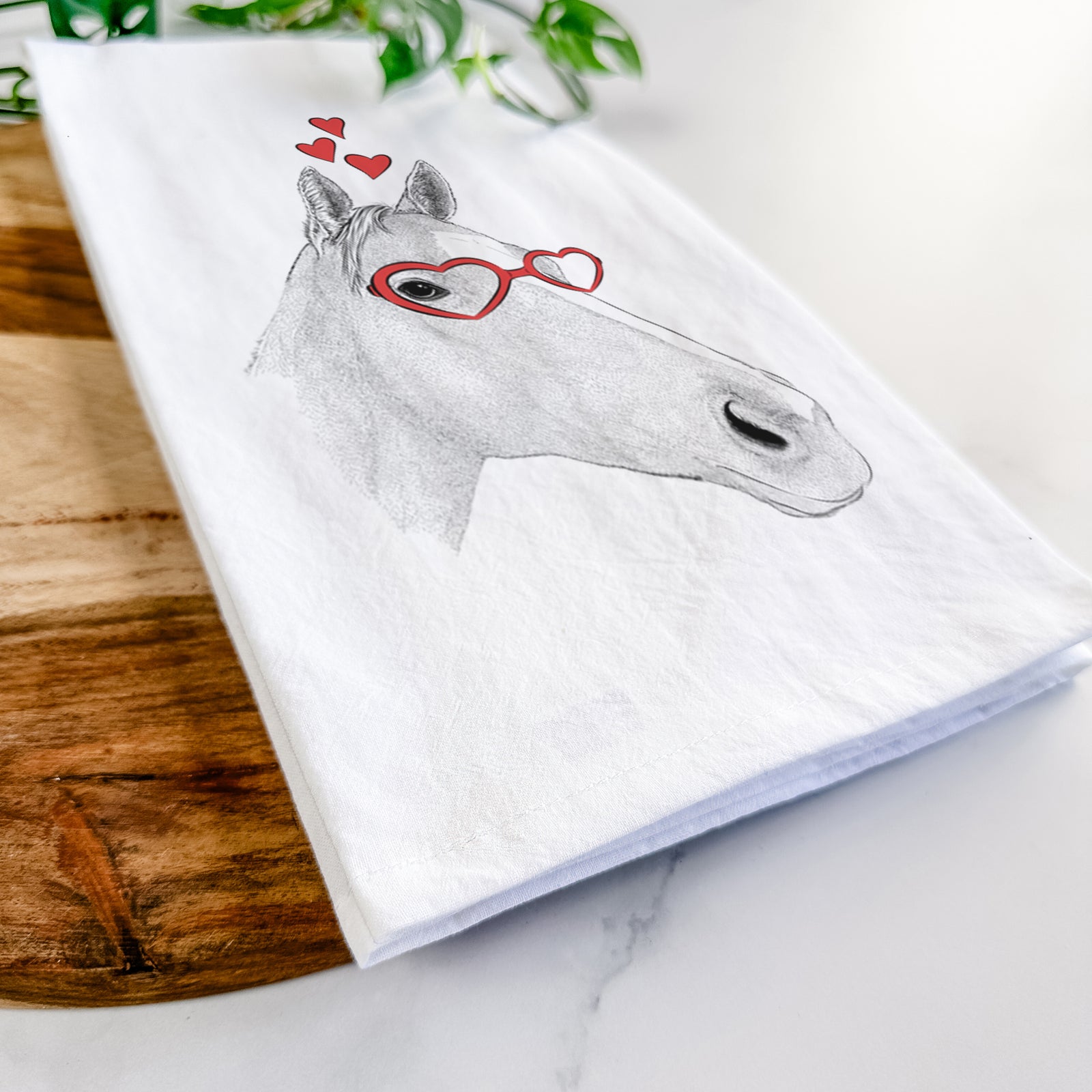 Hand-drawn sketch of Westley the Horse wearing heart-shaped glasses on a tea towel