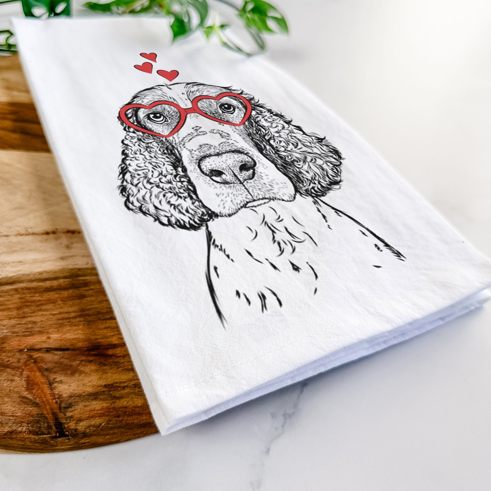 Hand-drawn sketch of Wilbur the English Springer Spaniel wearing heart-shaped glasses on a tea towel