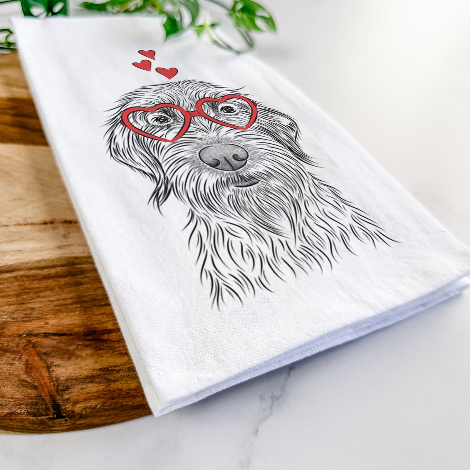 Hand-drawn sketch of Wilkins the Wirehaired Pointing Griffon wearing heart-shaped glasses on a tea towel