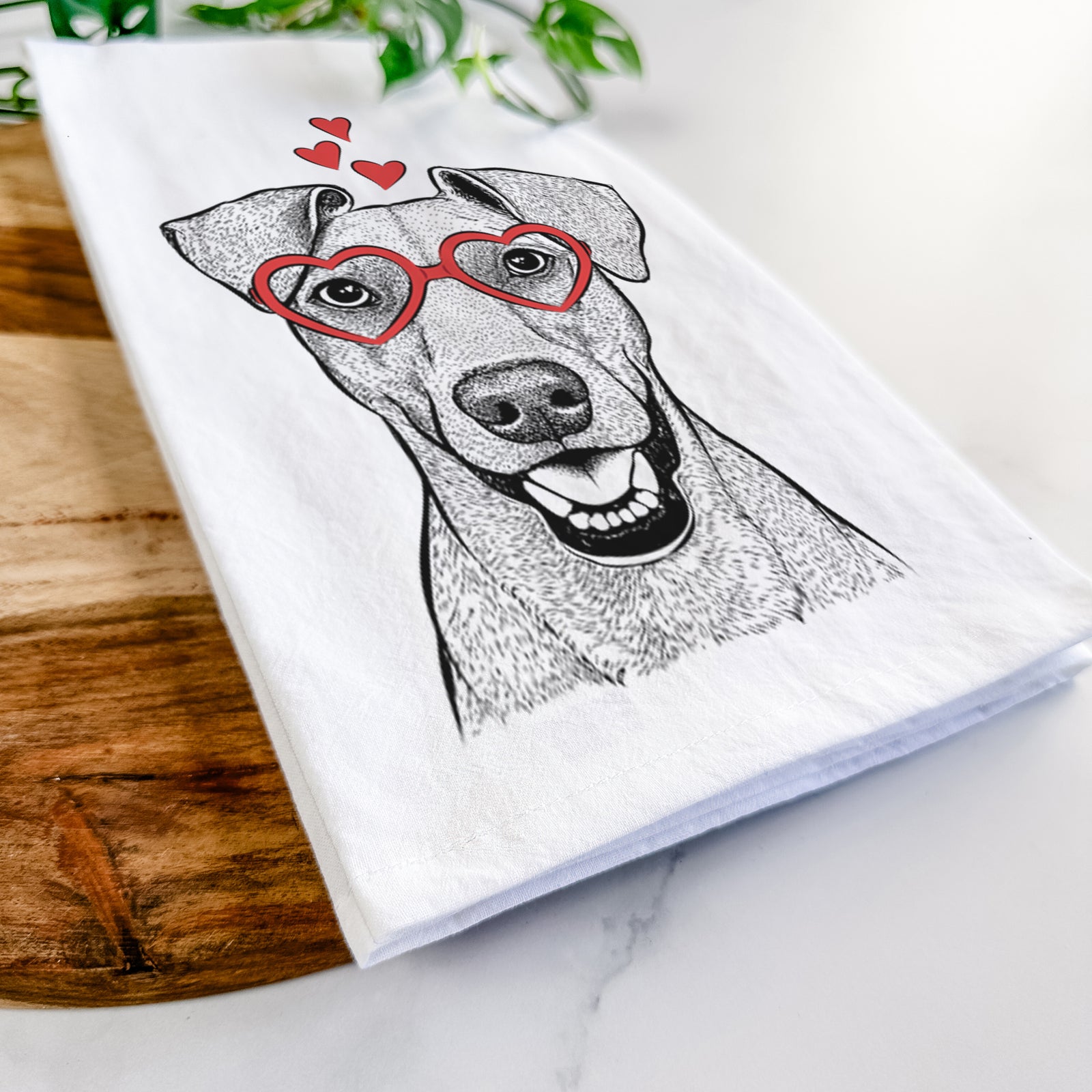 Hand-drawn sketch of Willow the German Pinscher wearing heart-shaped glasses on a tea towel