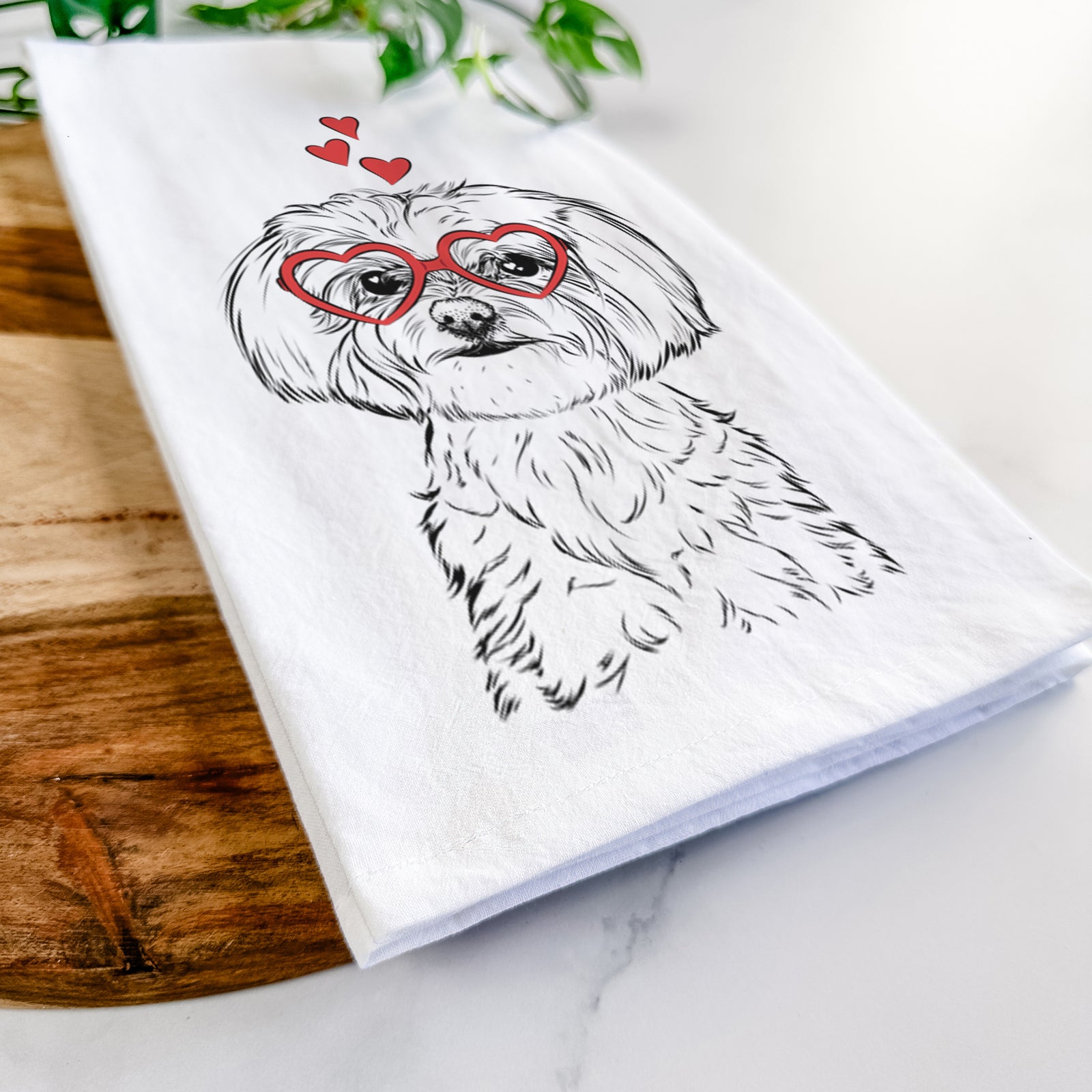 Hand-drawn sketch of Willow the Maltese wearing heart-shaped glasses on a tea towel