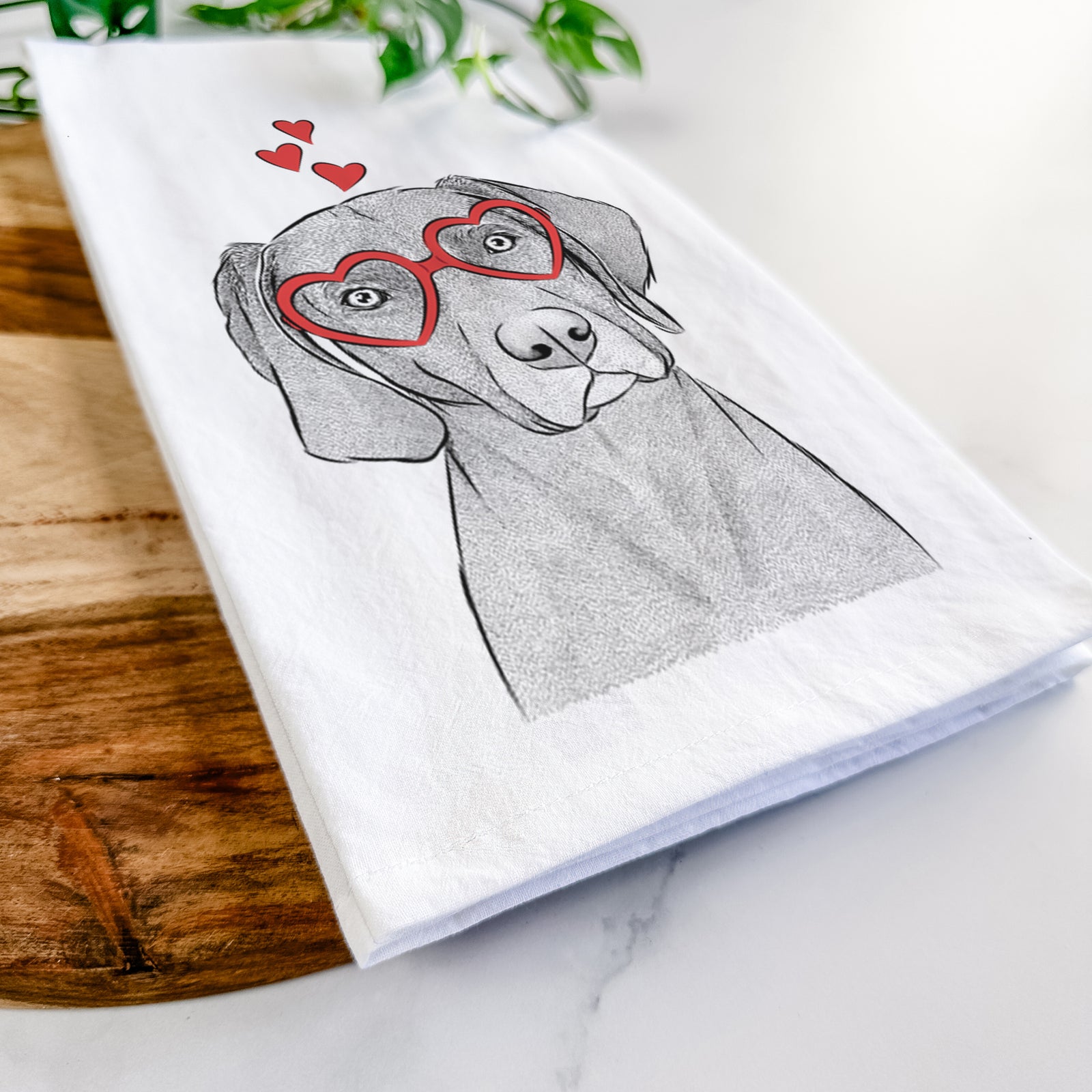Hand-drawn sketch of Willow the Weizsla wearing heart-shaped glasses on a tea towel