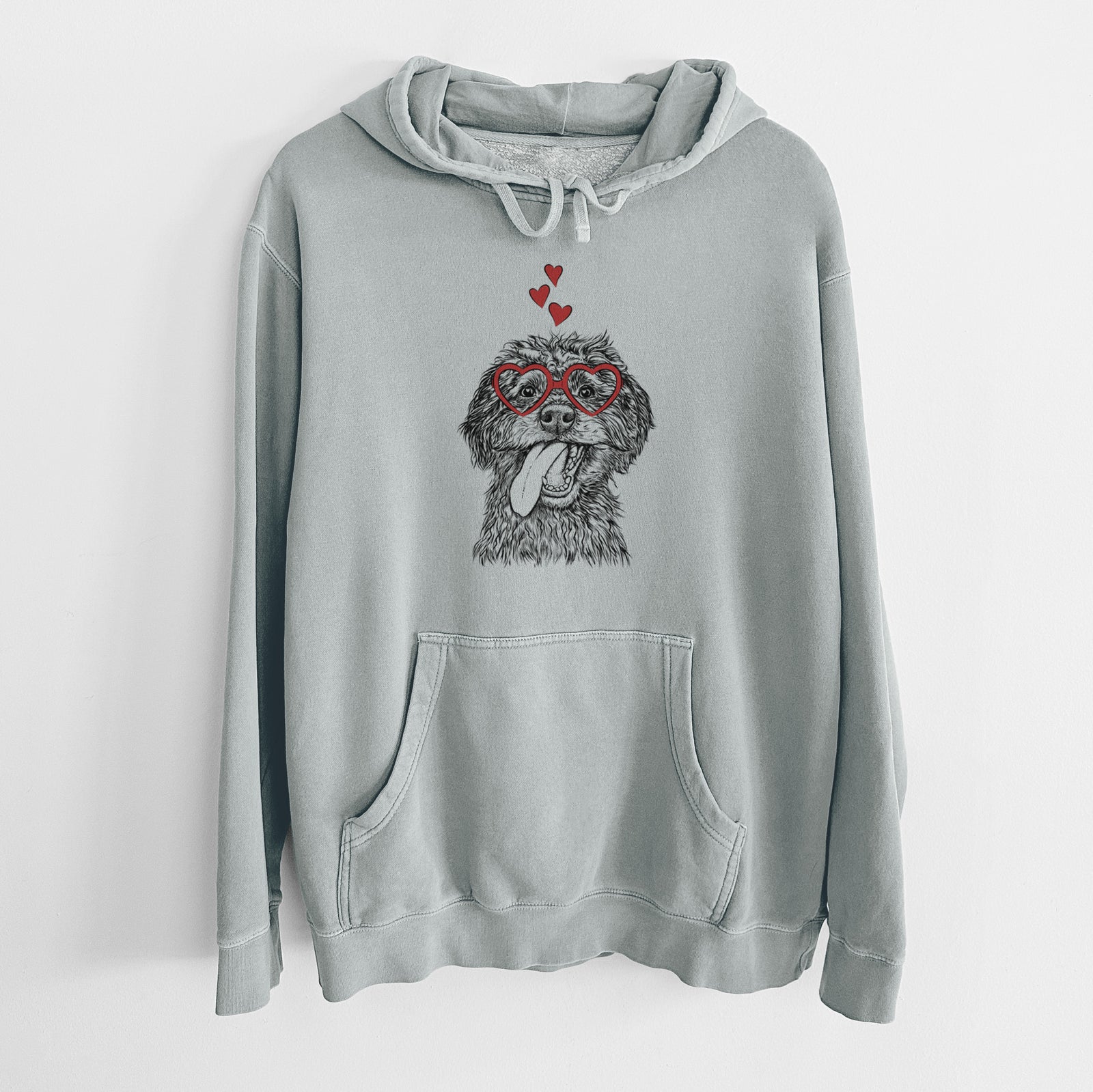 Hand-drawn sketch of Winnie the Mini Aussiedoodle wearing heart-shaped glasses on a Sage Unisex pigment dyed hoodie