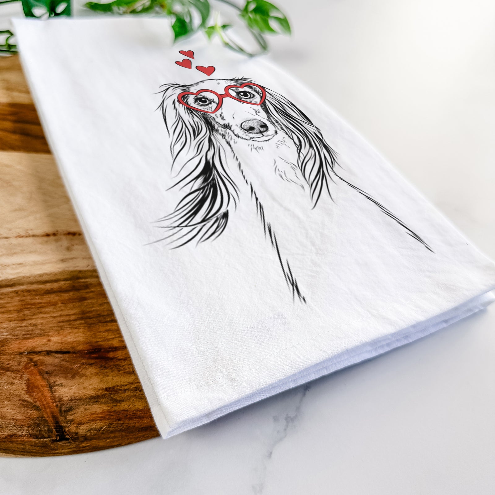 Hand-drawn sketch of Zahra the Saluki wearing heart-shaped glasses on a tea towel