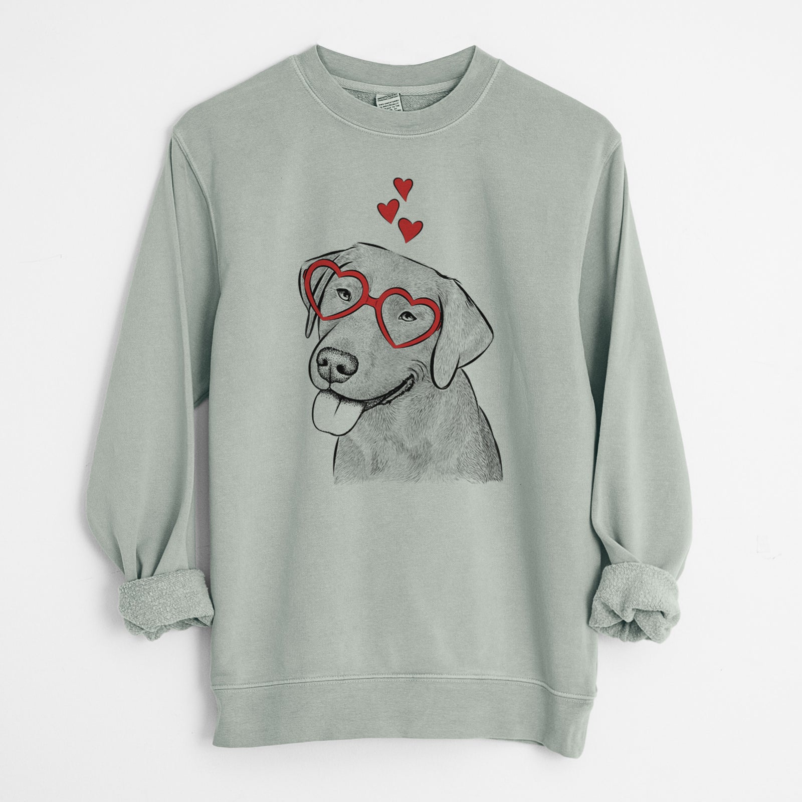 Hand-drawn sketch of Zeppelin the Black Labrador wearing heart-shaped glasses on a Sage Unisex pigment dyed crew sweatshirt