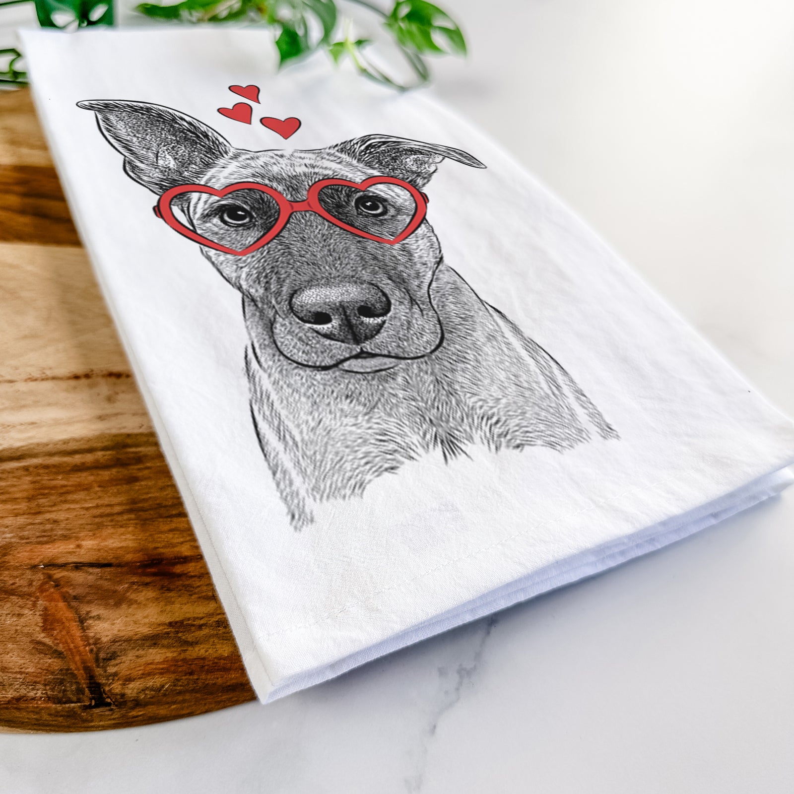 Hand-drawn sketch of Zoey the Mixed Breed wearing heart-shaped glasses on a tea towel
