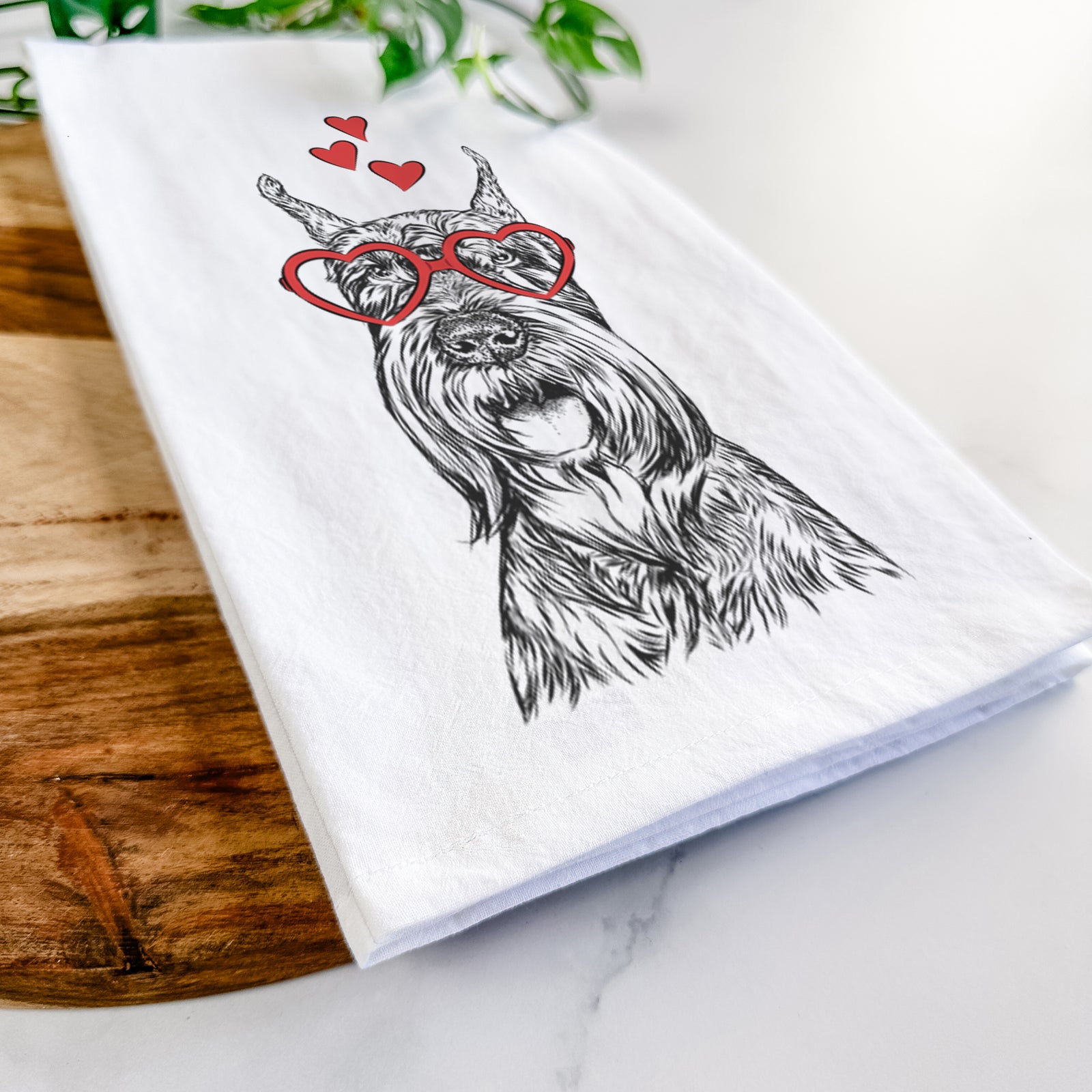 Hand-drawn sketch of Zuri the Giant Schnauzer wearing heart-shaped glasses on a tea towel