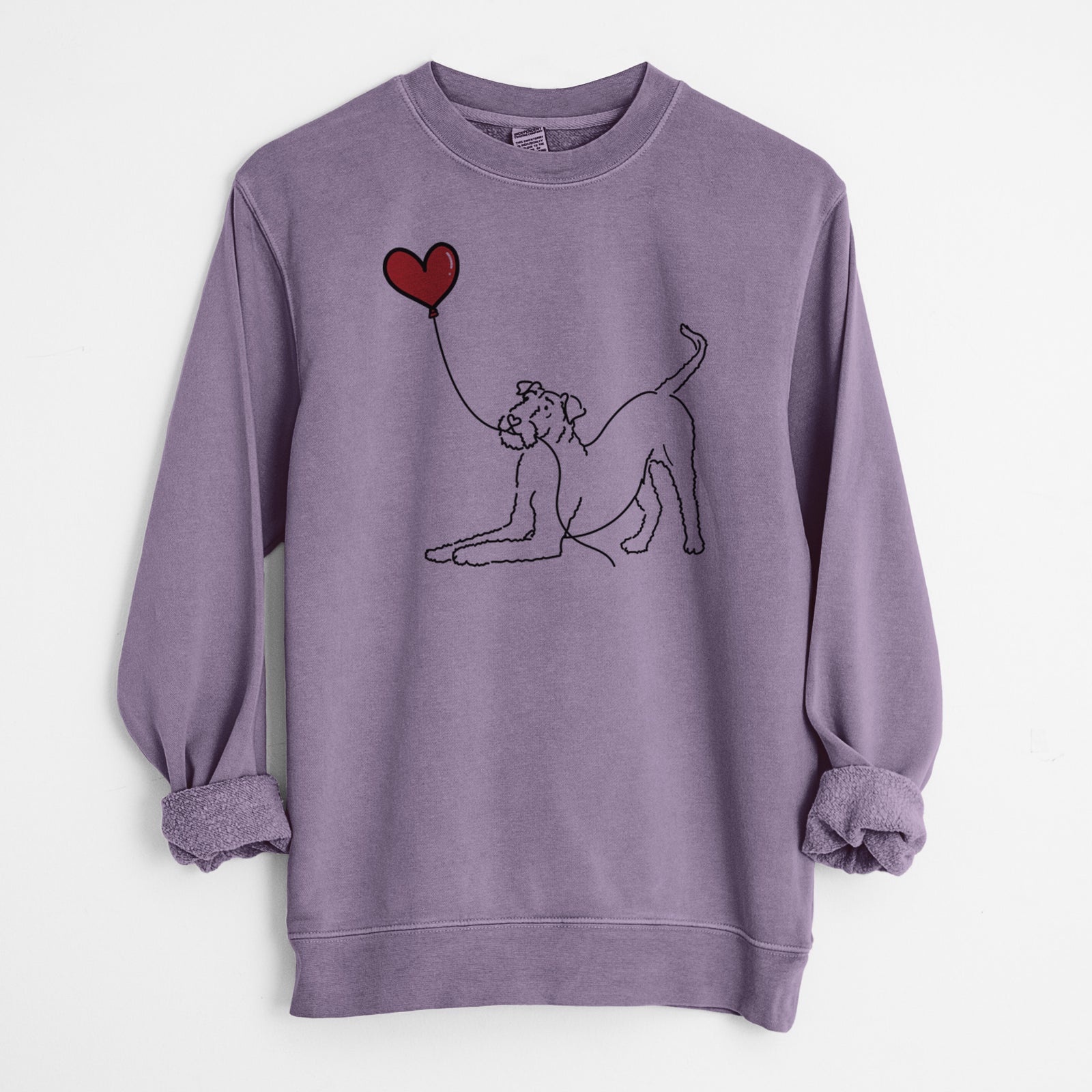 Minimalist line drawing of an Airedale Terrier Heart String holding a heart balloon on a Plum Unisex pigment dyed crew sweatshirt