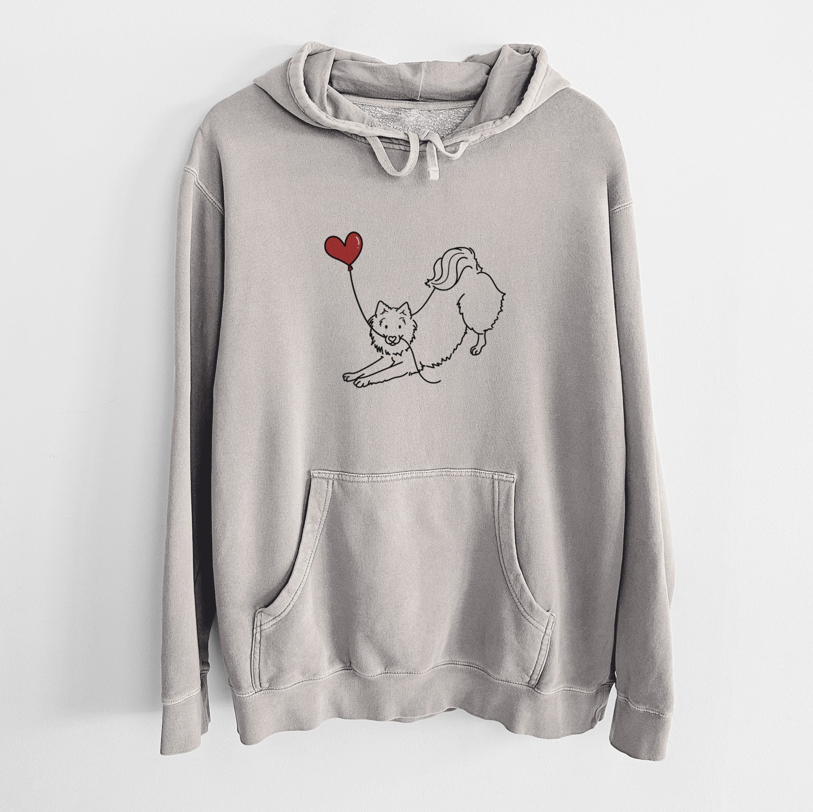 Minimalist line drawing of an American Eskimo Heart String holding a heart balloon on a Cement Unisex pigment dyed hoodie