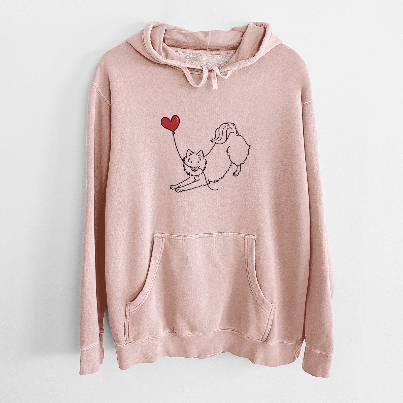Minimalist line drawing of an American Eskimo Heart String holding a heart balloon on a Dusty Pink Unisex pigment dyed hoodie
