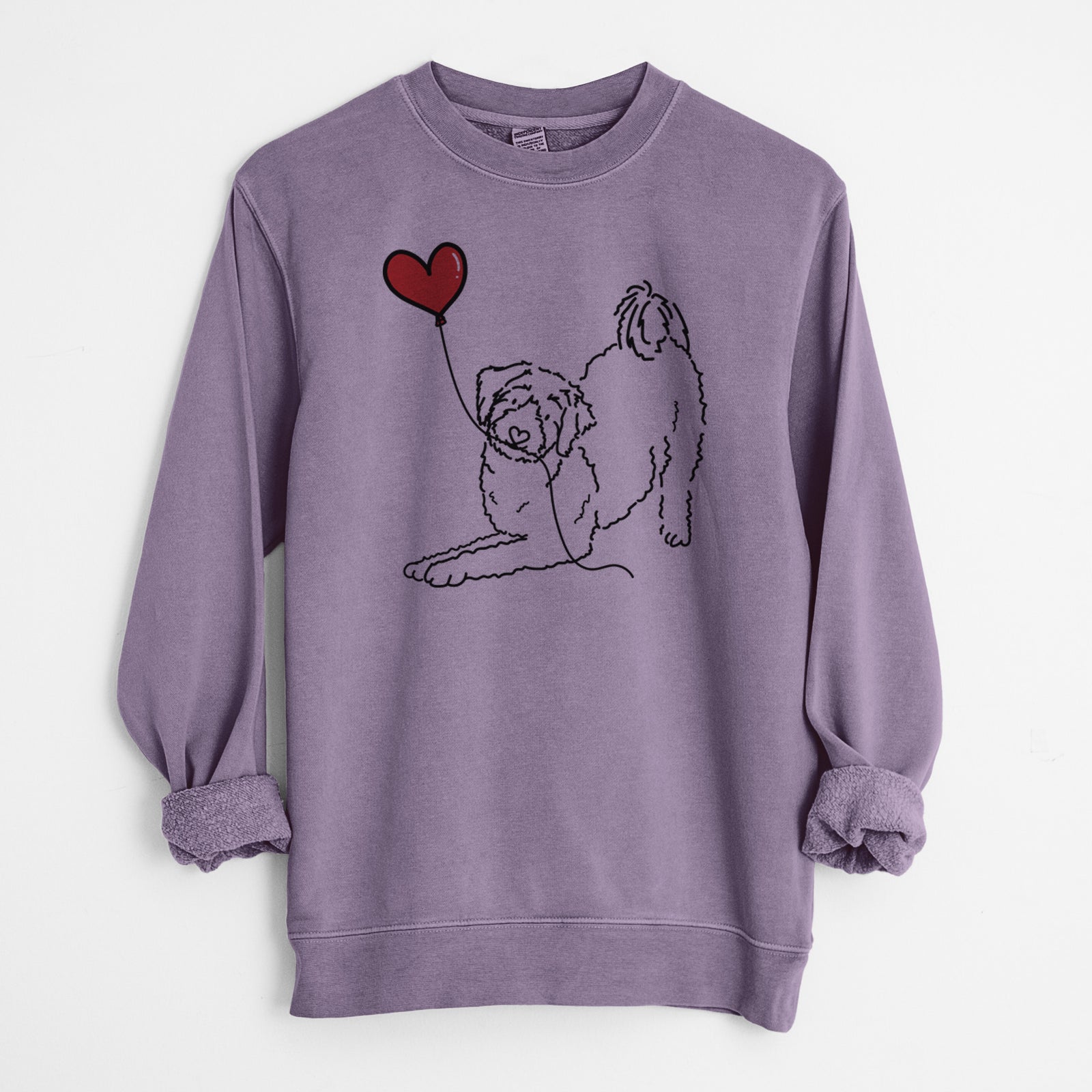 Minimalist line drawing of an Aussiedoodle Heart String holding a heart balloon on a Plum Unisex pigment dyed crew sweatshirt
