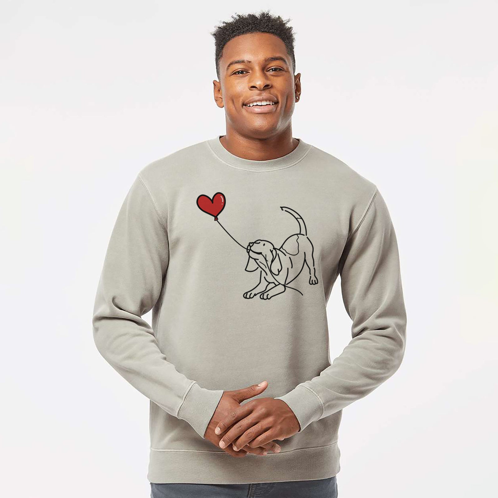 Minimalist line drawing of a Beagle Heart String holding a heart balloon on a Cement Unisex pigment dyed crew sweatshirt