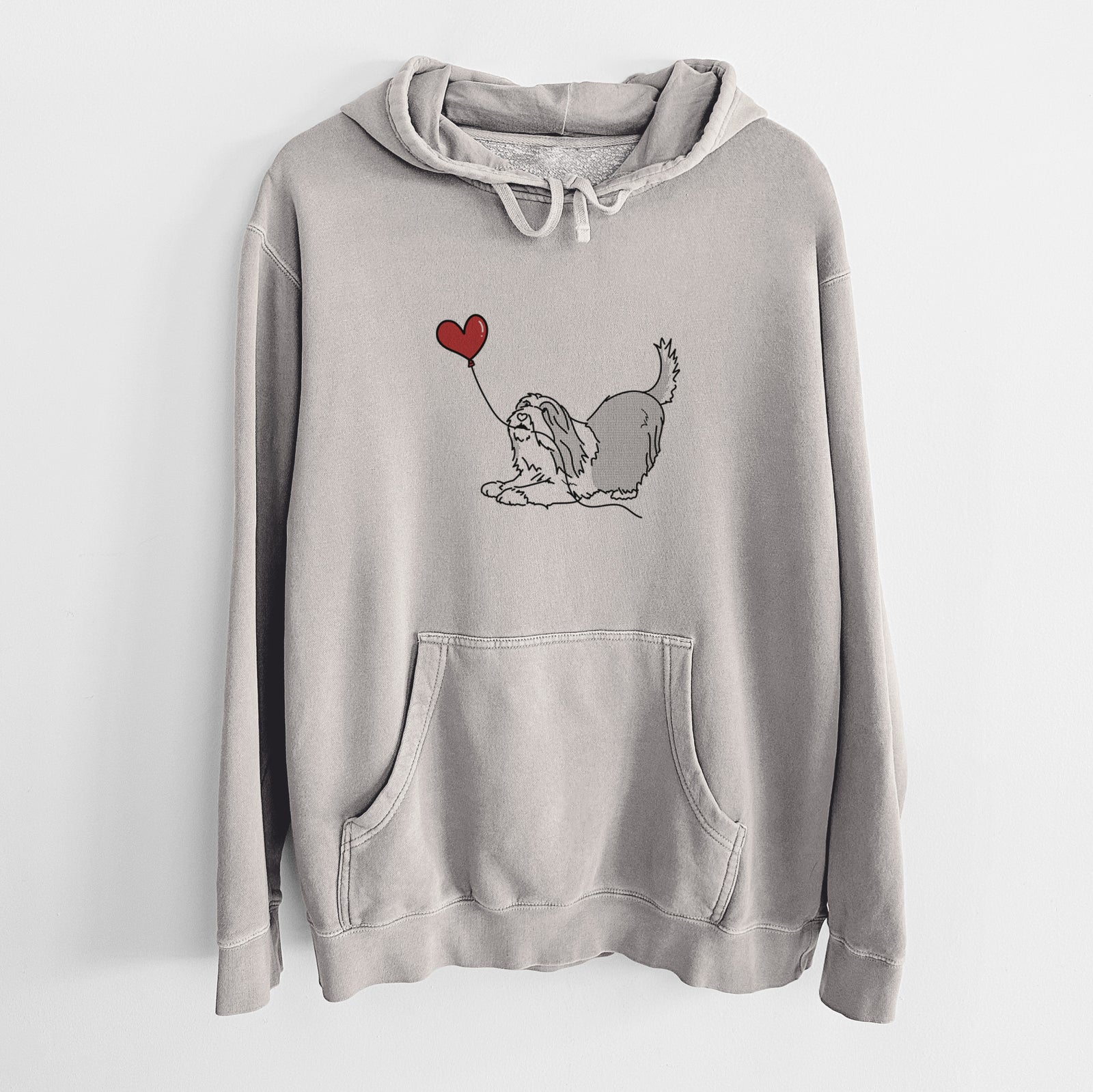 Minimalist line drawing of a Bearded Collie Heart String holding a heart balloon on a Cement Unisex pigment dyed hoodie
