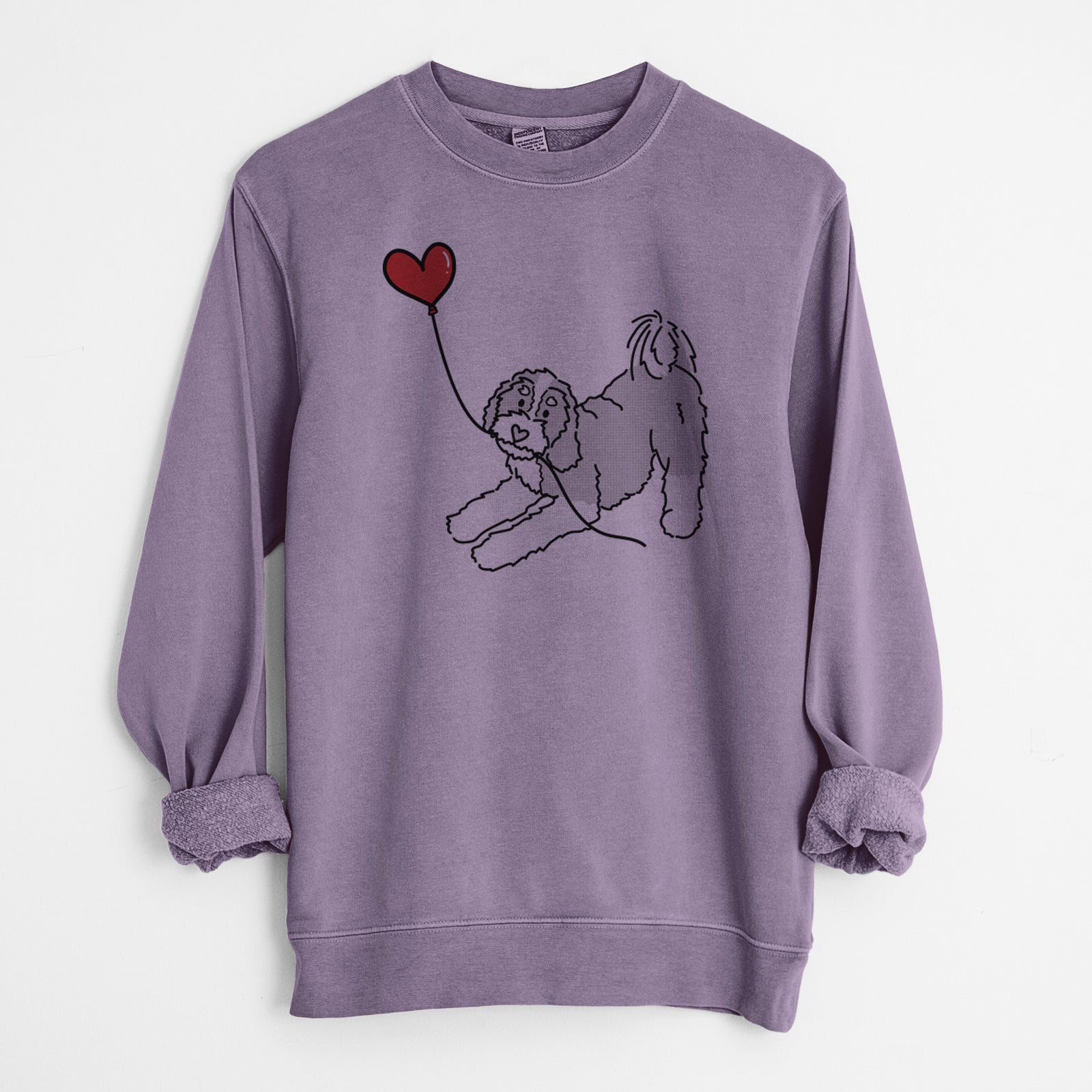 Minimalist line drawing of a Bernedoodle Heart String holding a heart balloon on a Plum Unisex pigment dyed crew sweatshirt